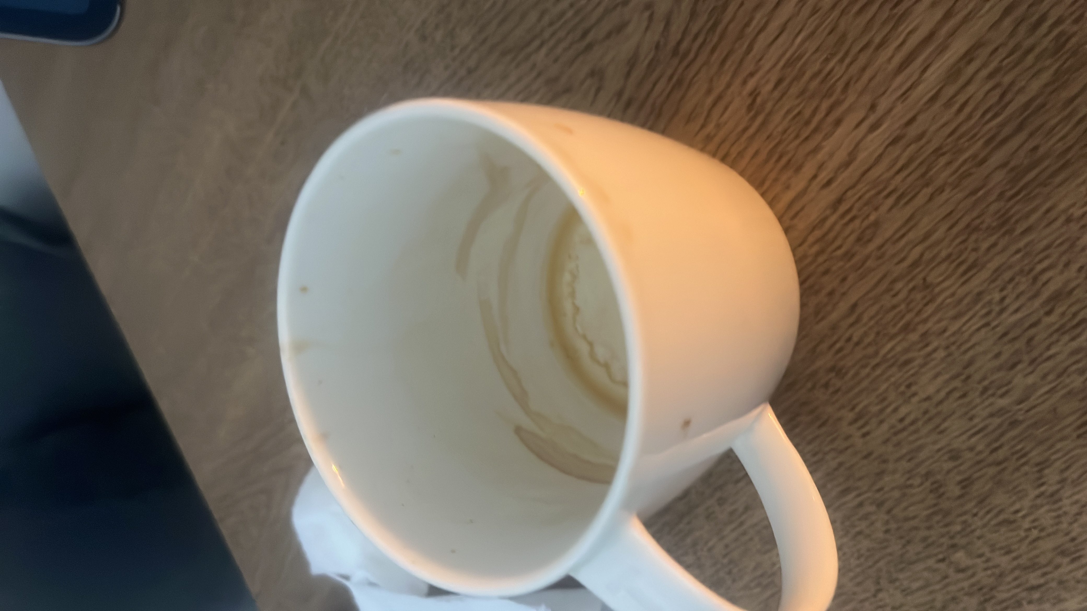 The image shows an empty cup with coffee residue, indicating that the beverage consumed was likely coffee, which typically has minimal calories, fats, proteins, and carbs unless additives like sugar or milk were included.