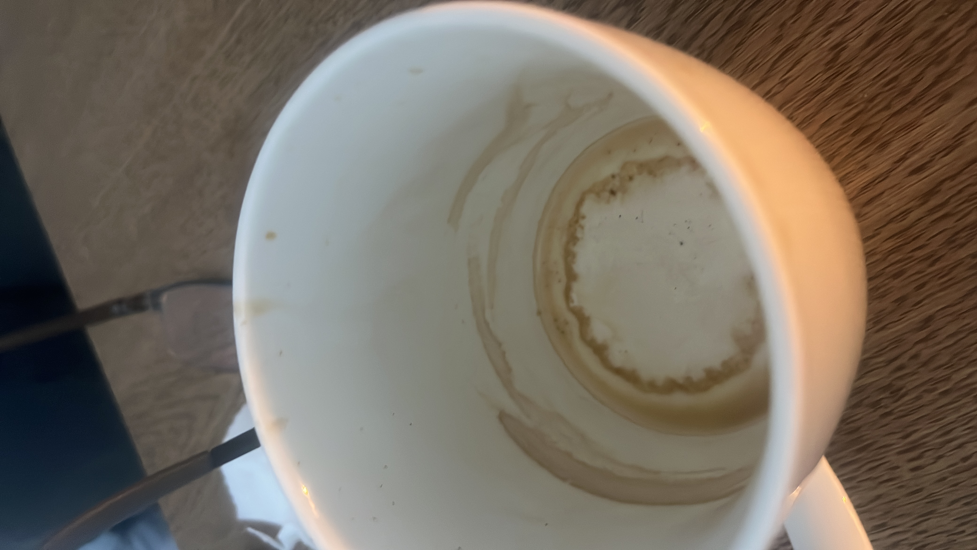The image shows an empty cup with coffee residue, indicating that the beverage consumed was likely black coffee or a similar low-calorie drink.