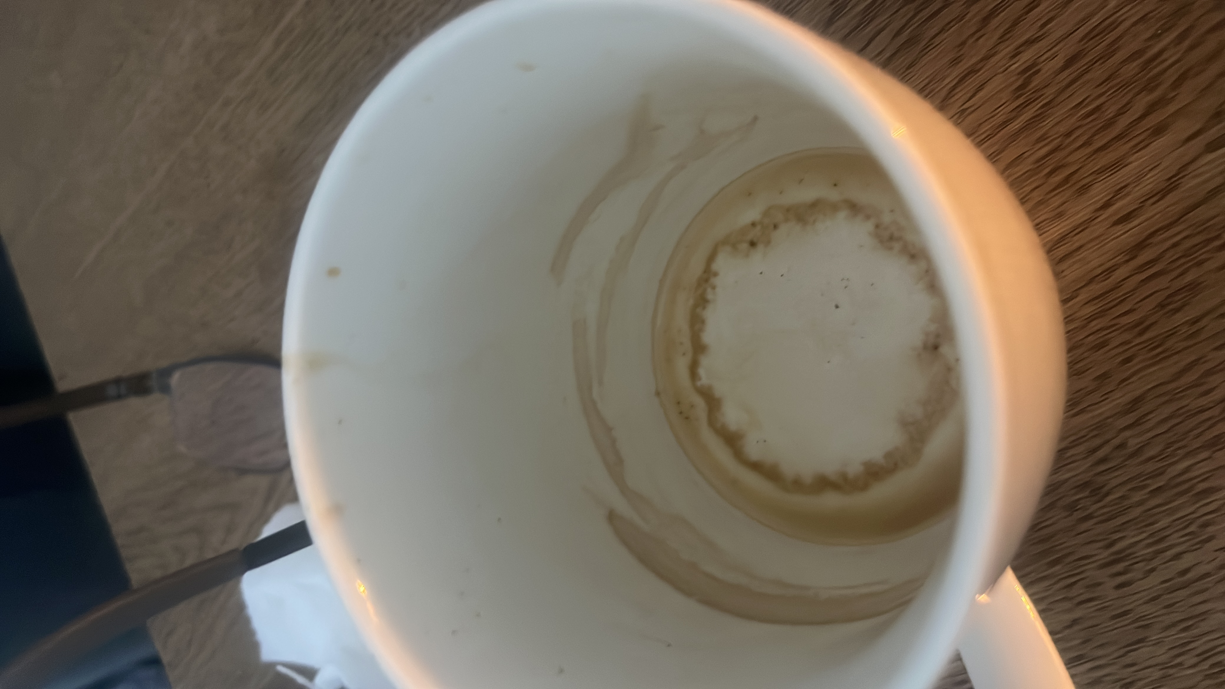 The image shows an empty cup with coffee residue, indicating that the beverage consumed was likely coffee or a similar drink. No significant nutritional content remains.