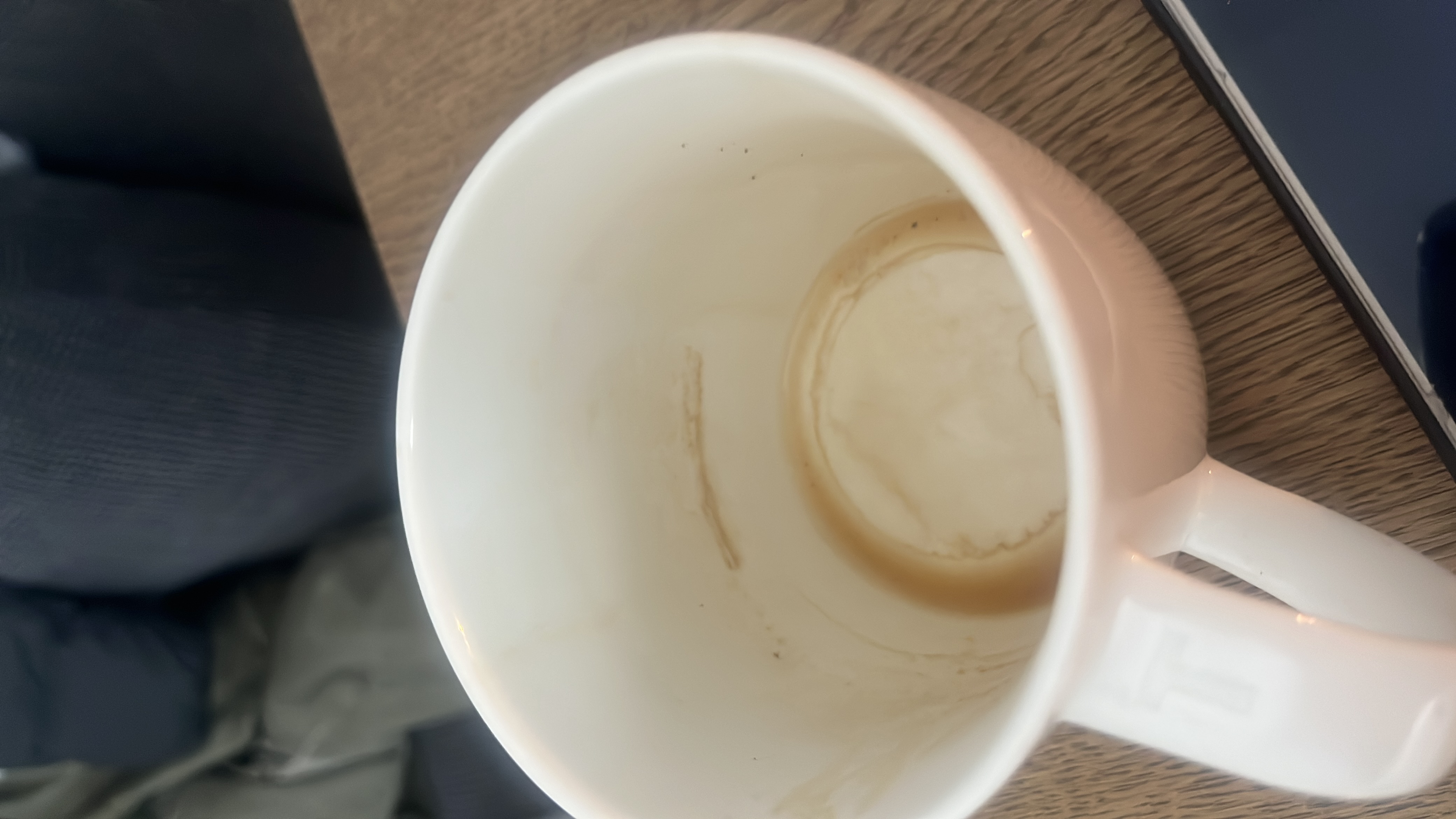 An empty cup with coffee residue, indicating that the beverage consumed was likely black coffee or a similar low-calorie drink.