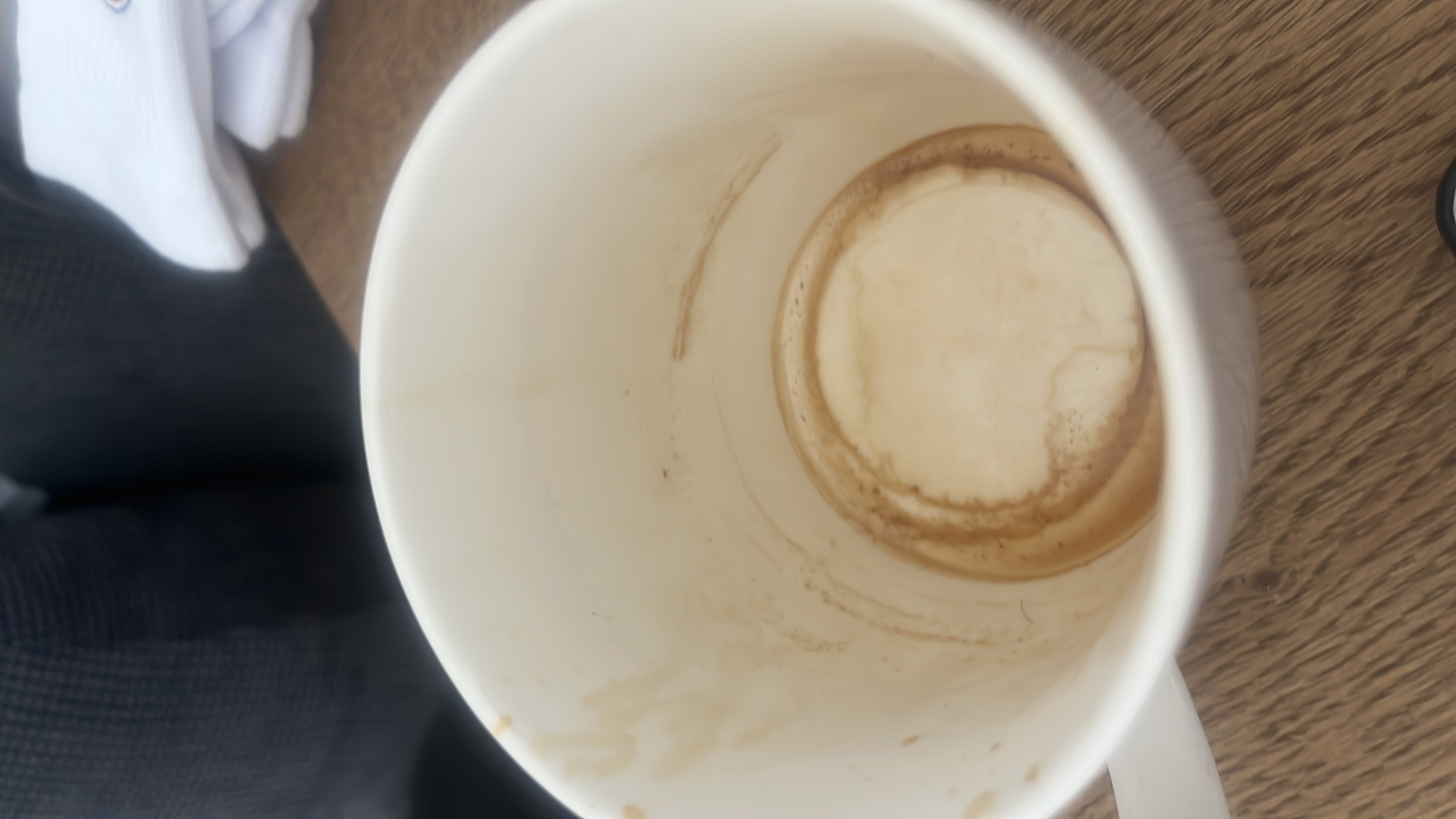 The image shows an empty cup with coffee residue, indicating that the beverage consumed was likely coffee or a similar drink. No significant nutritional content remains.