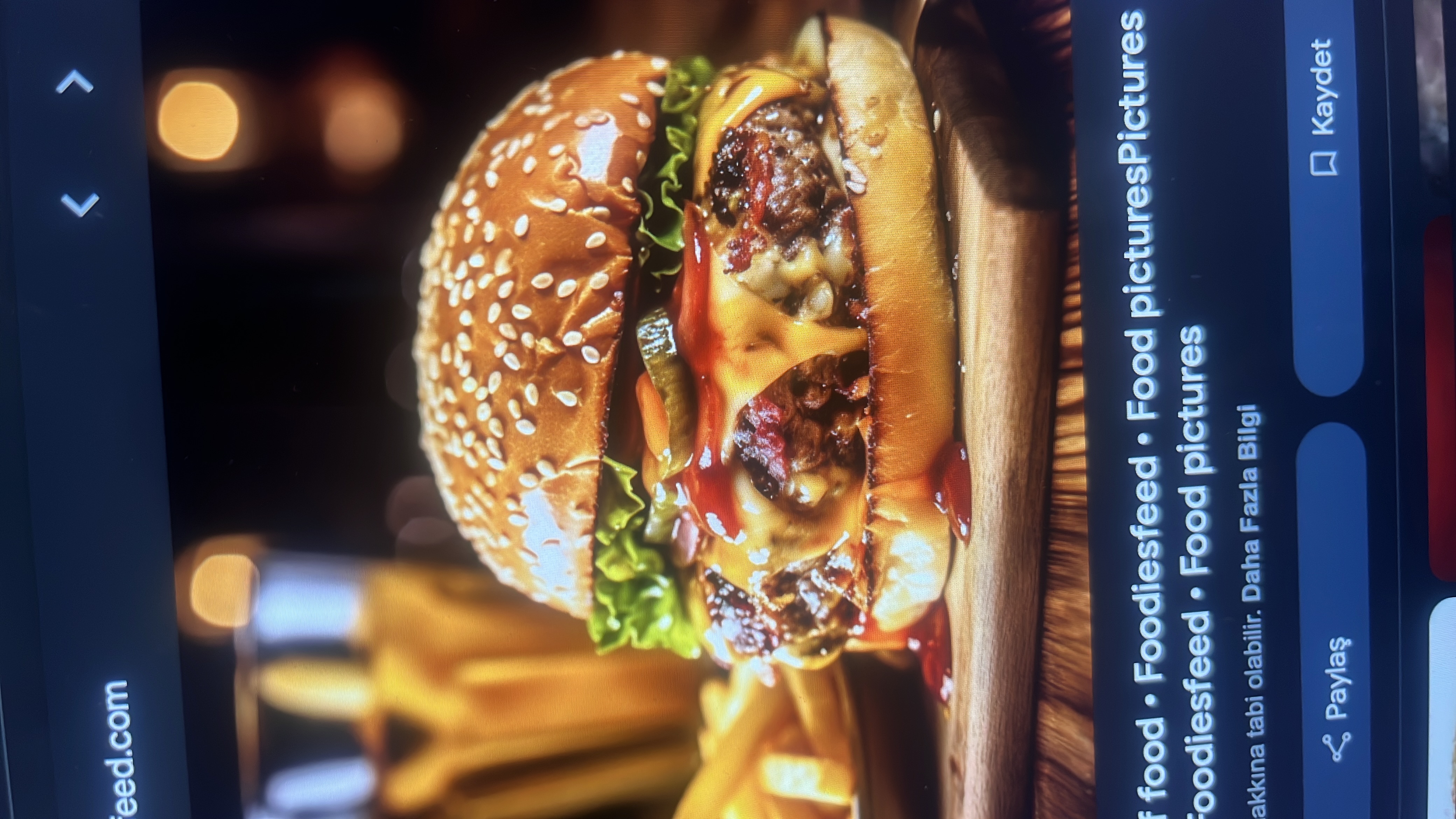 A cheeseburger with a beef patty, lettuce, pickles, ketchup, and a side of fries.