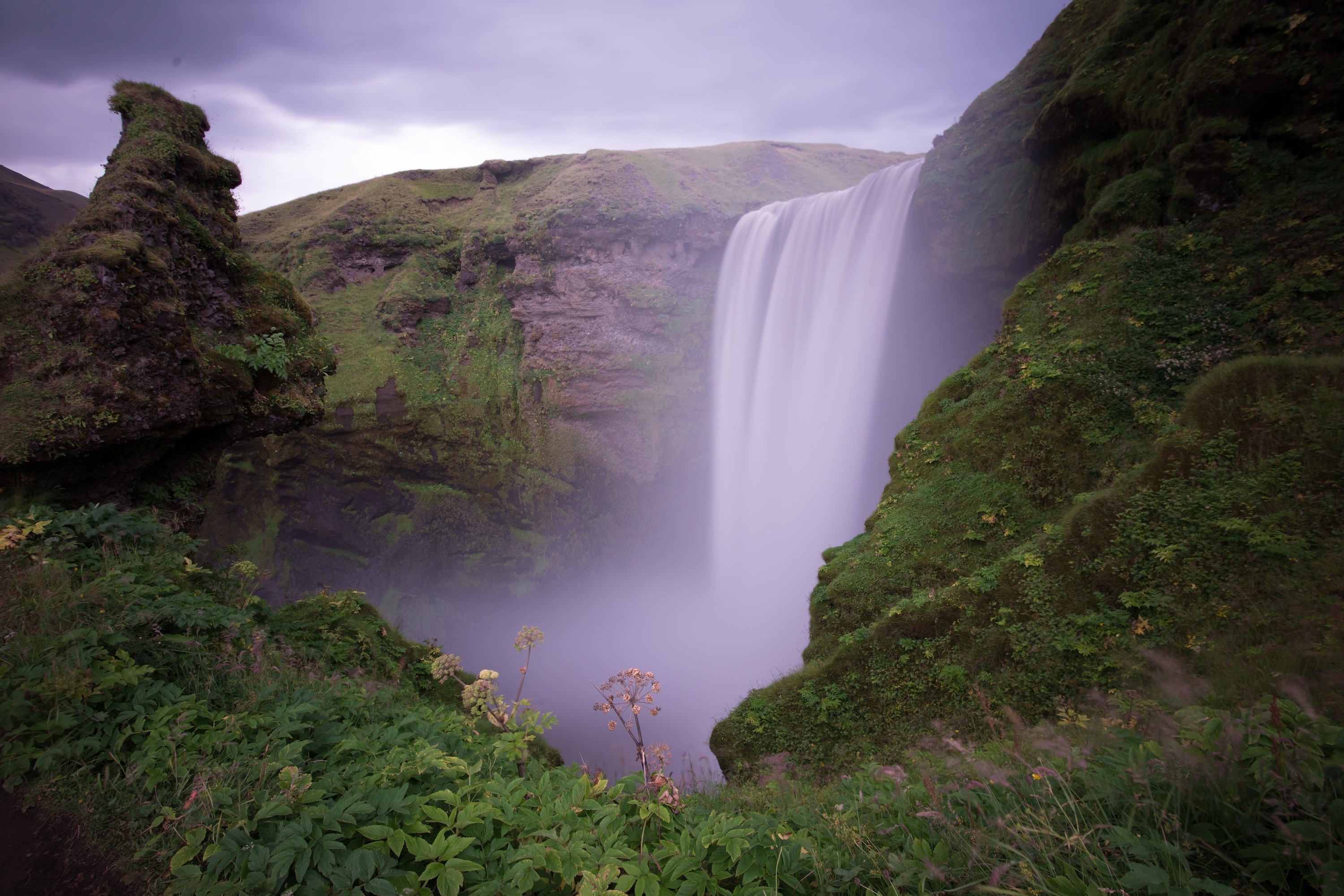 The image depicts a natural waterfall surrounded by lush greenery, unrelated to nutritional information.
