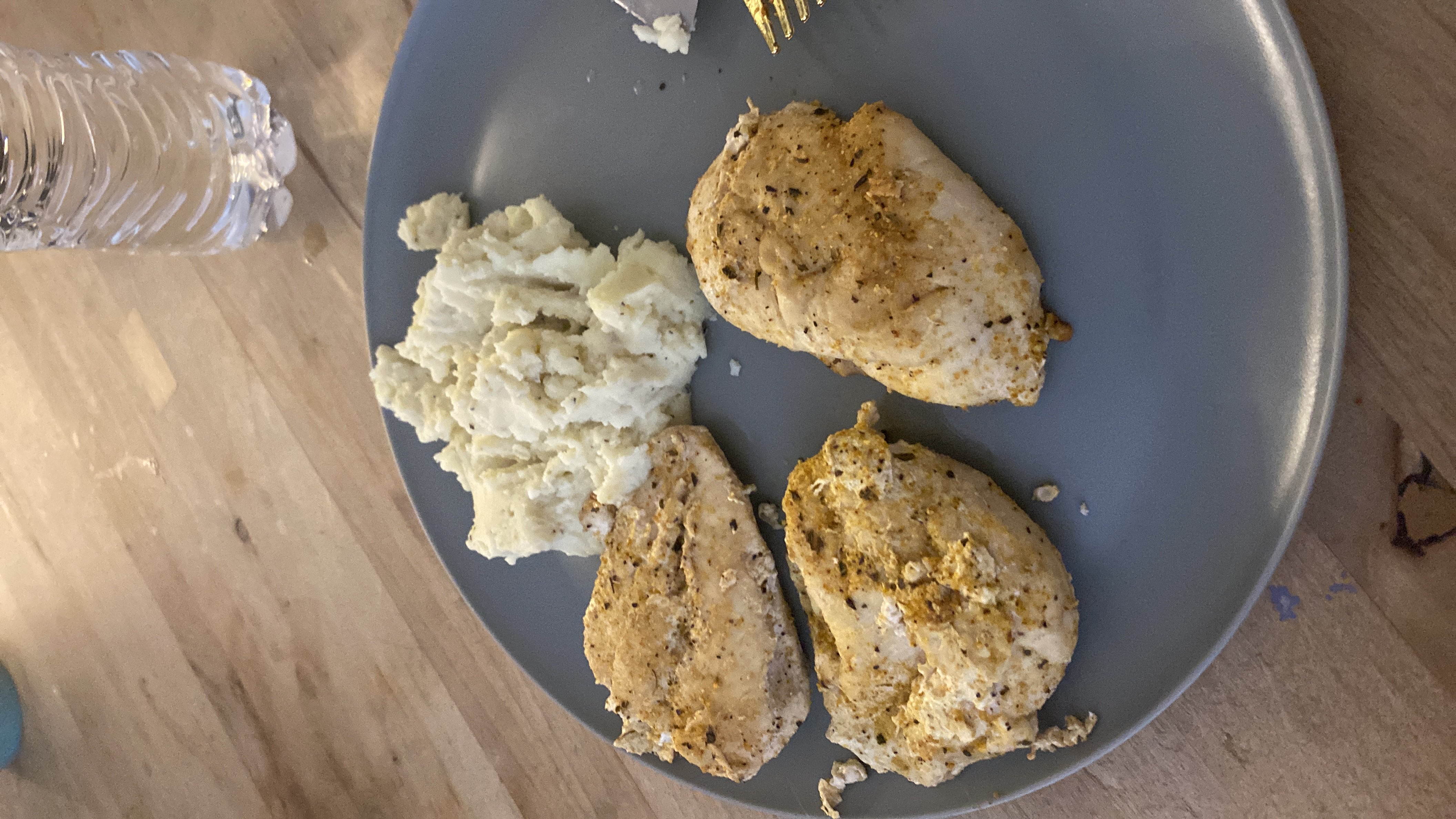 A plate of grilled chicken and mashed potatoes, providing a balanced meal with high protein and moderate carbs.
