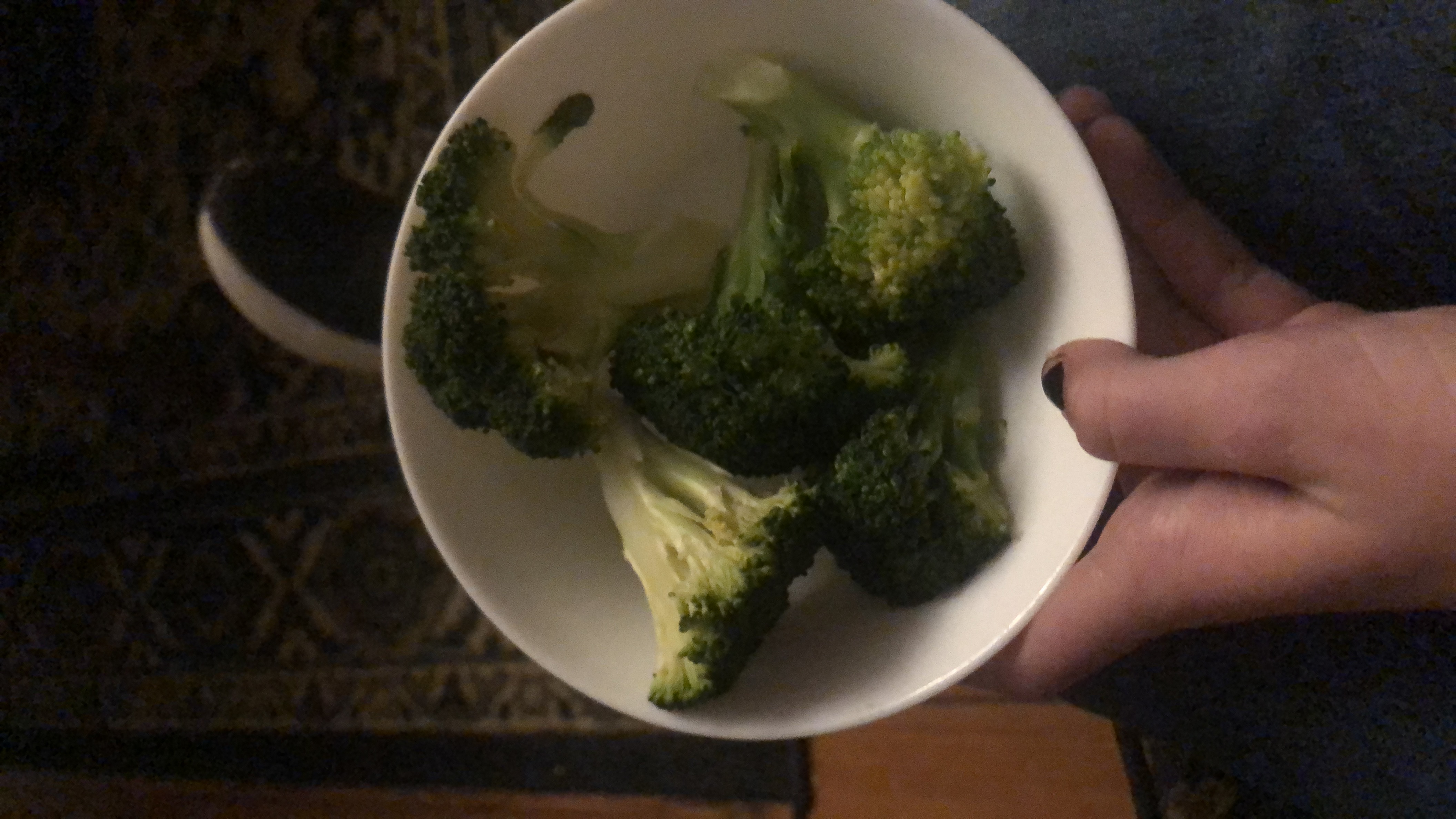 A bowl of steamed broccoli, a low-calorie and nutrient-dense vegetable rich in vitamins and fiber.