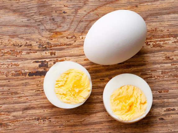 The image shows a whole egg and a halved boiled egg, which are nutritious and high in protein.