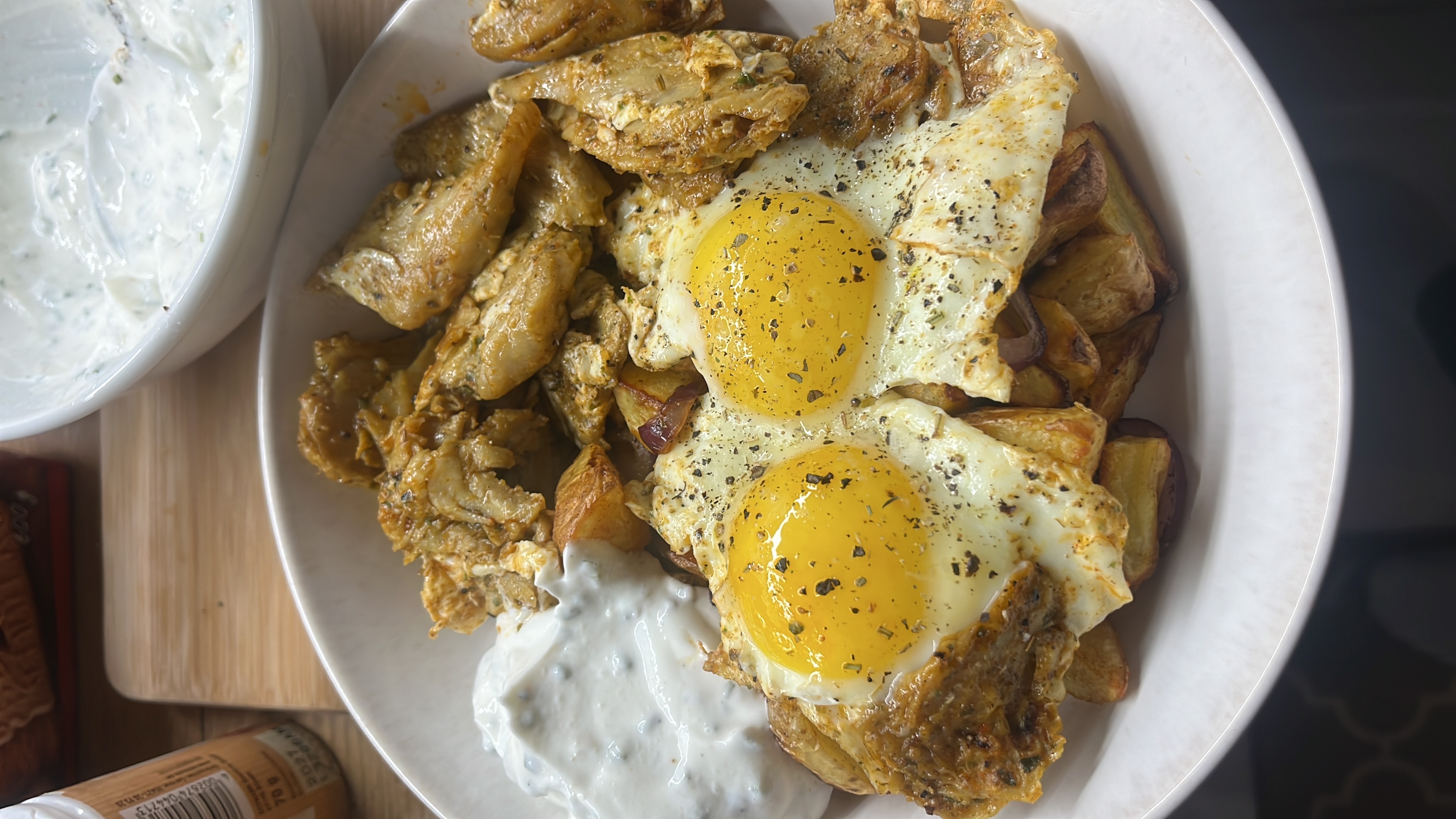 A high-protein dish featuring eggs, soy-based substitute, roasted potatoes, and a yogurt-based sauce.