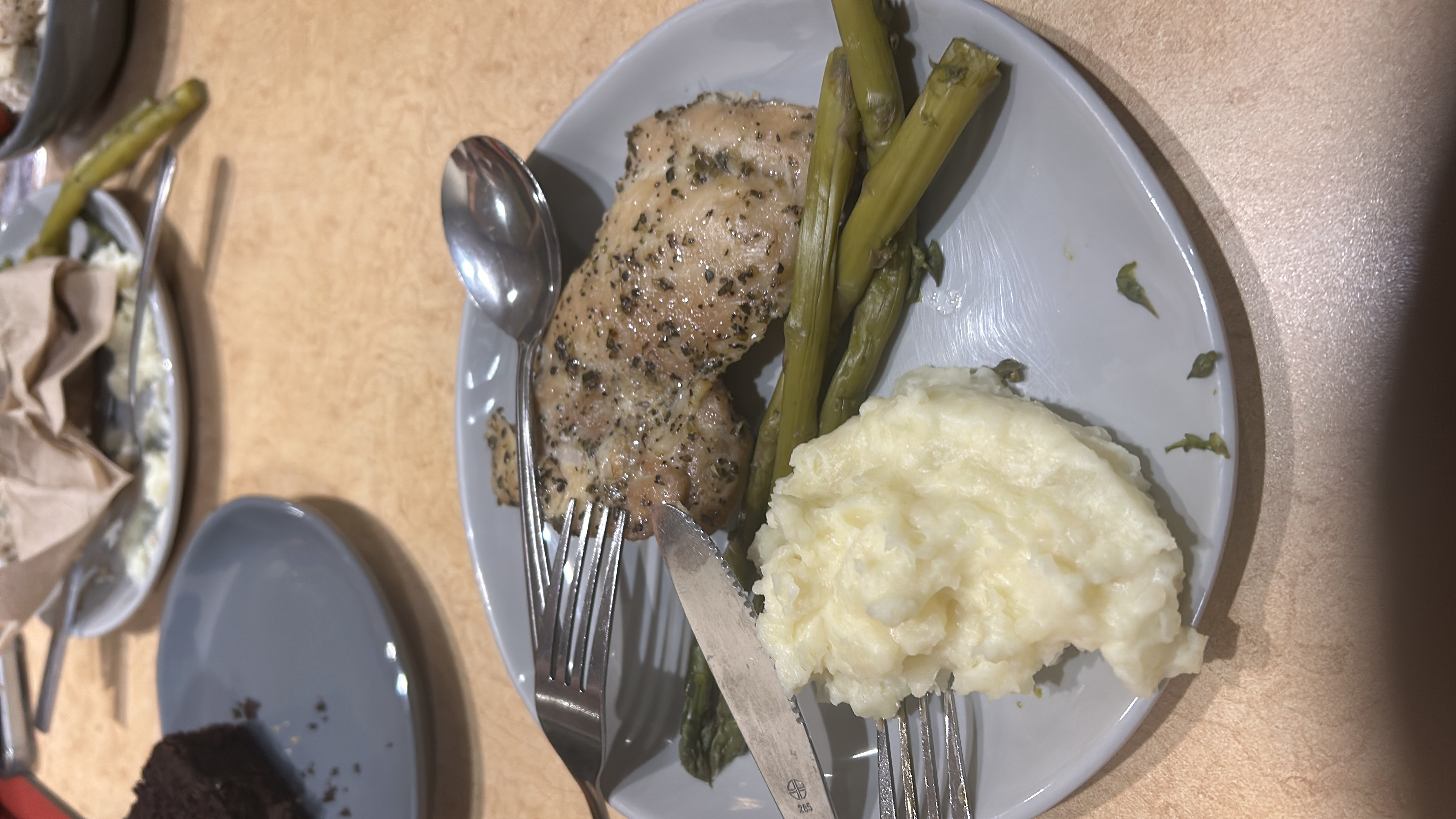 A balanced meal consisting of herb-seasoned chicken, mashed potatoes, and steamed asparagus.
