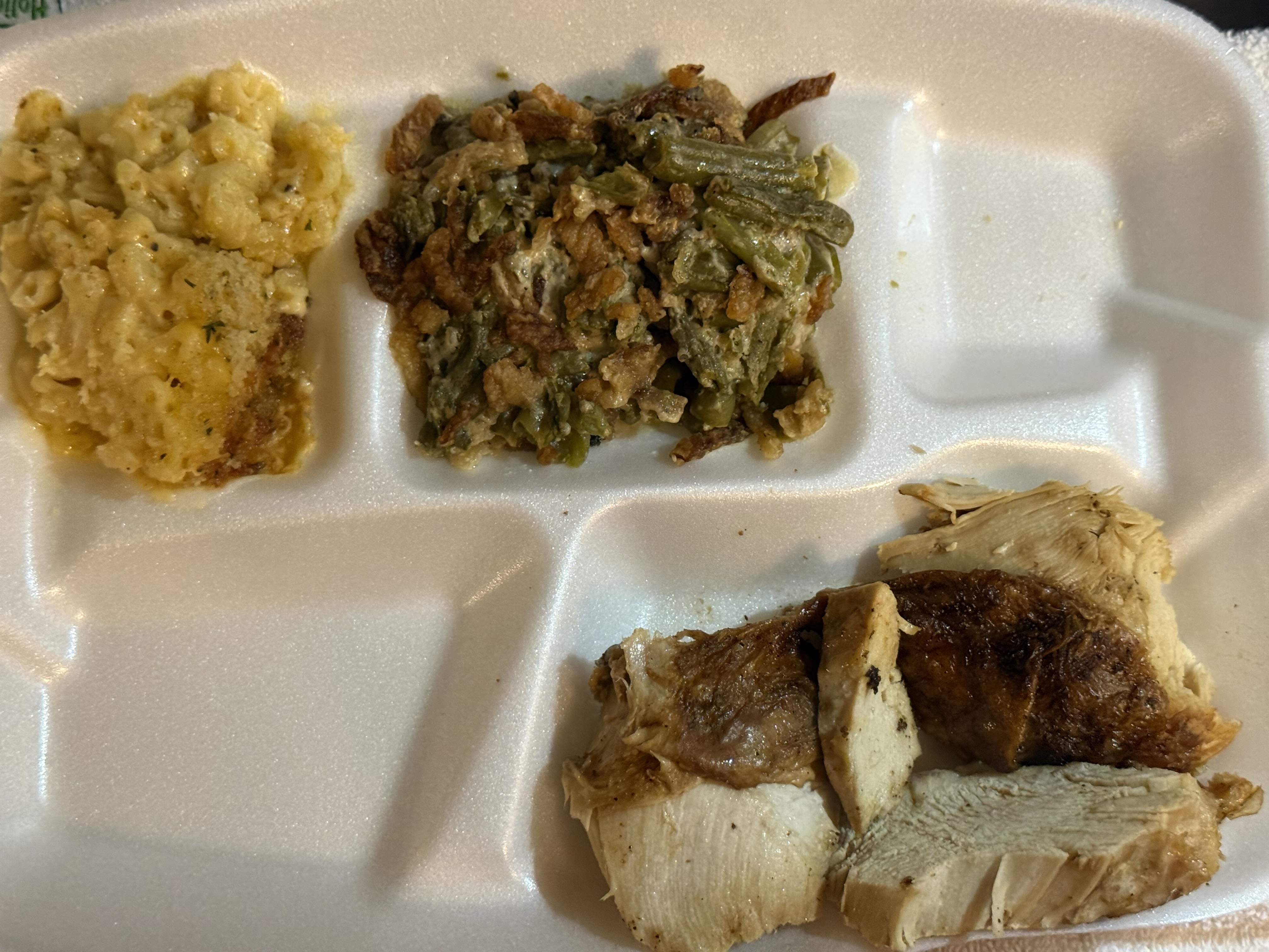 A meal consisting of half portion fried turkey, green bean casserole, and mac and cheese, providing a balanced mix of protein, carbs, and fats.