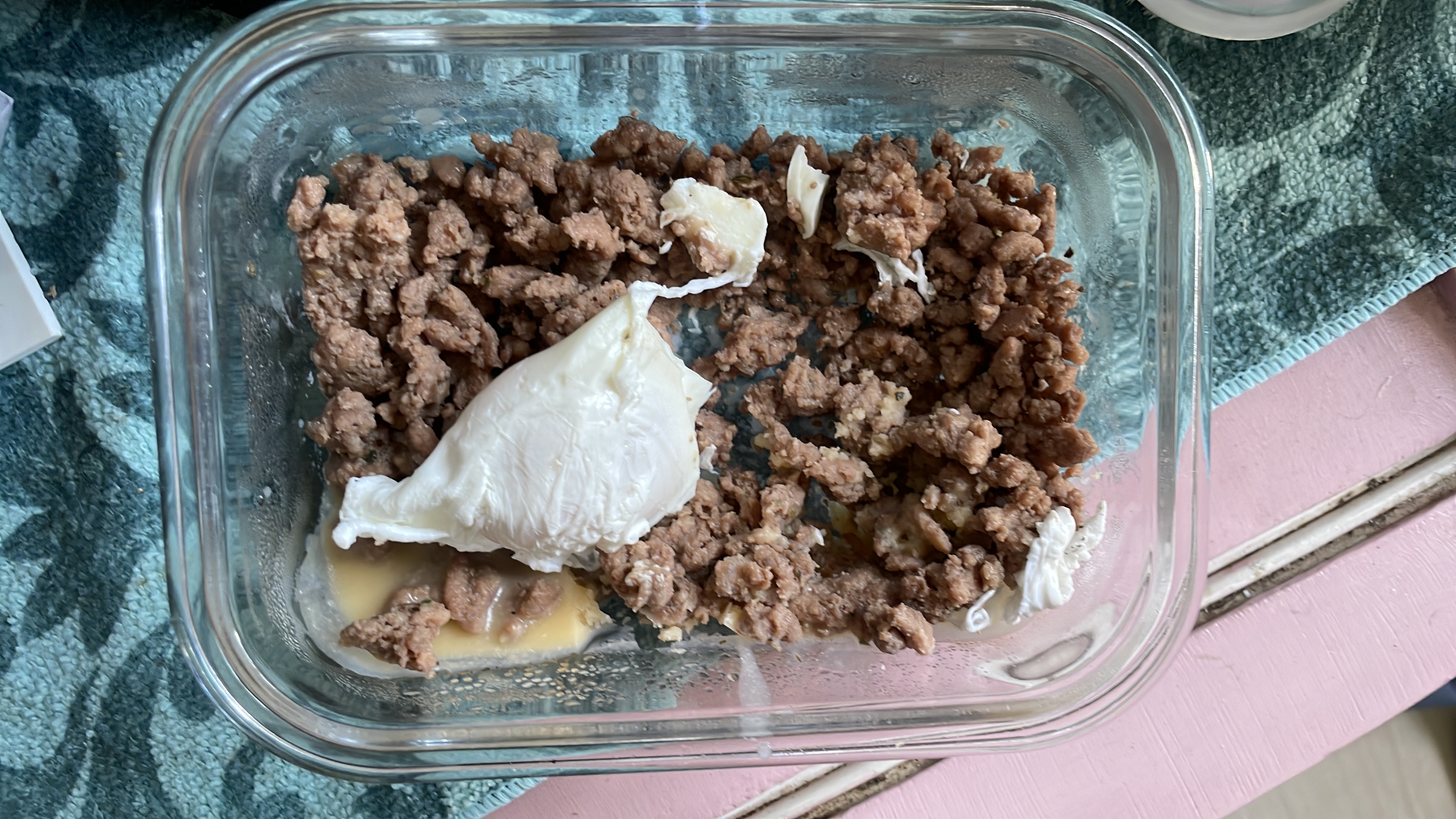 A high-protein meal consisting of 200 grams of ground beef and a poached egg, low in carbohydrates and moderately high in fats.