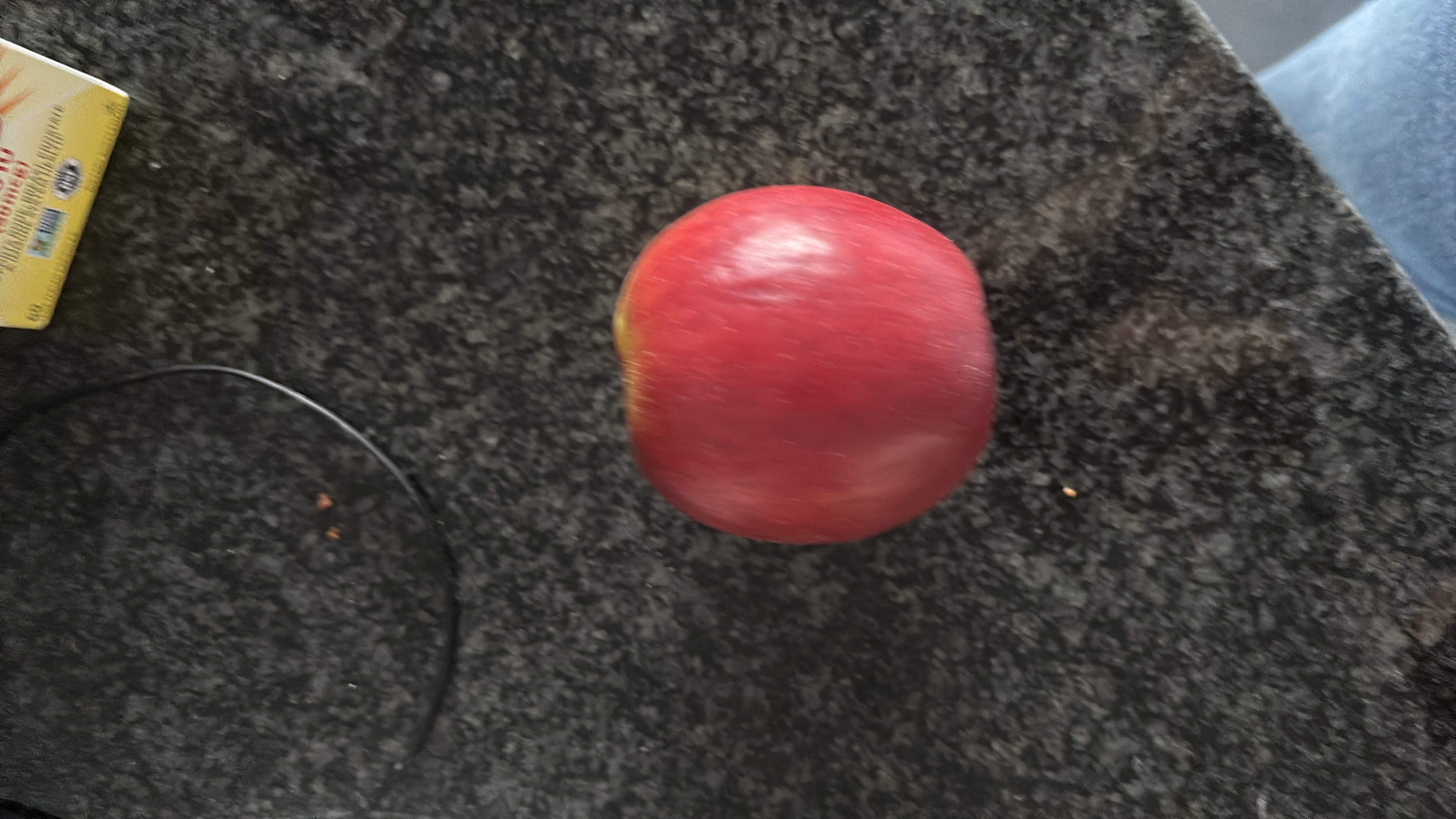 A fresh red apple, a nutritious fruit rich in carbohydrates and low in fats and protein.