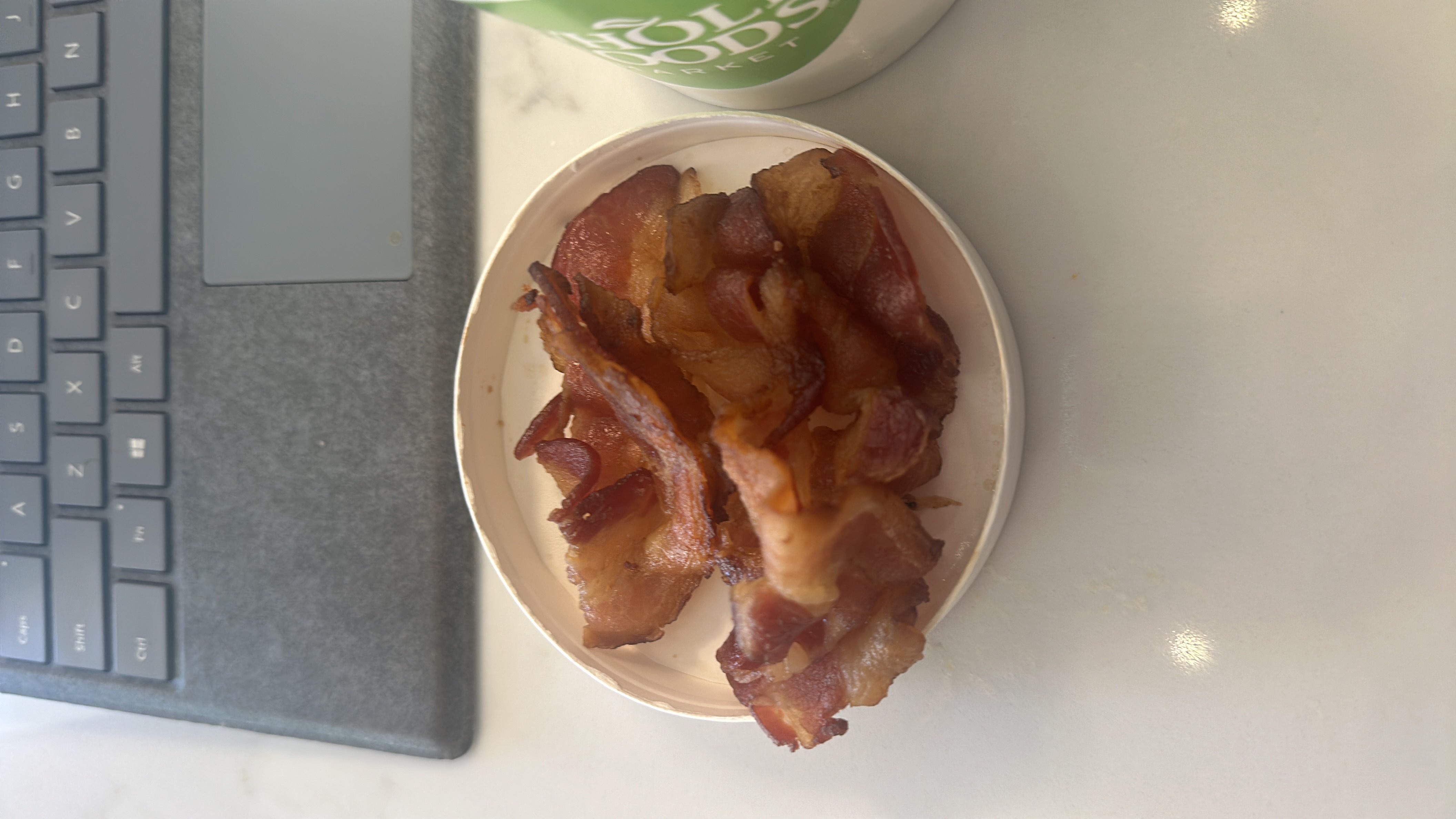 A serving of crispy bacon strips, high in protein and fats, with no carbohydrates.