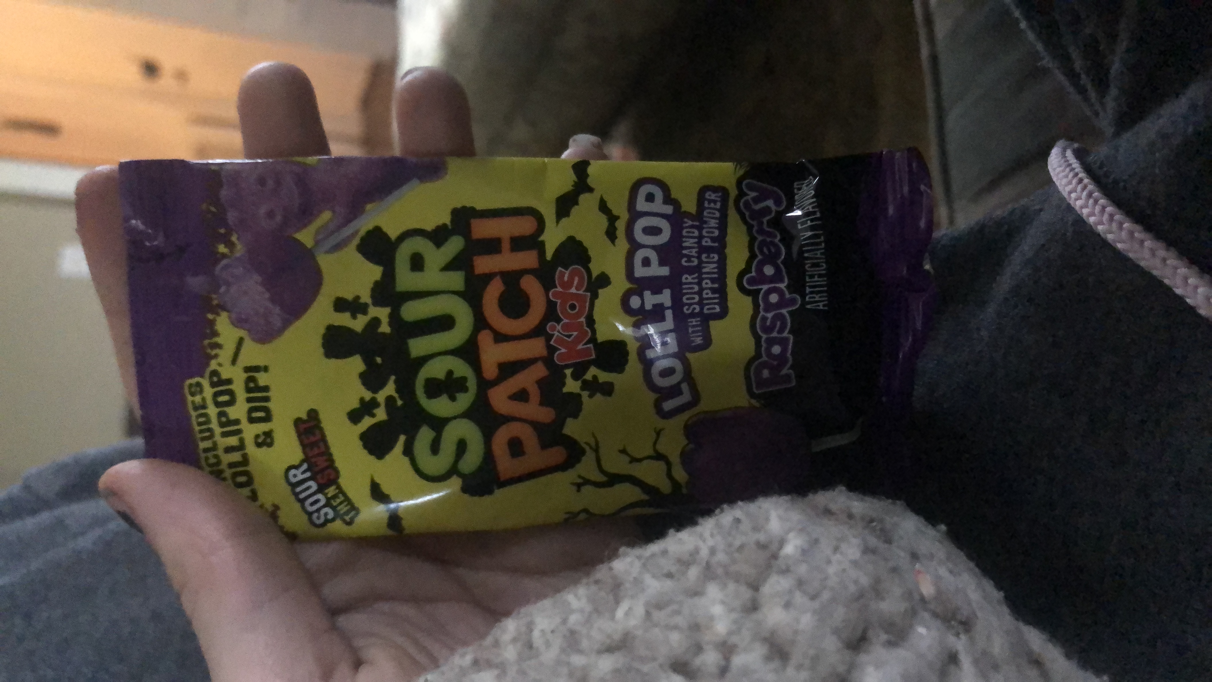 Sour Patch Kids Lollipop with sour candy dipping powder, raspberry flavor, artificially flavored.