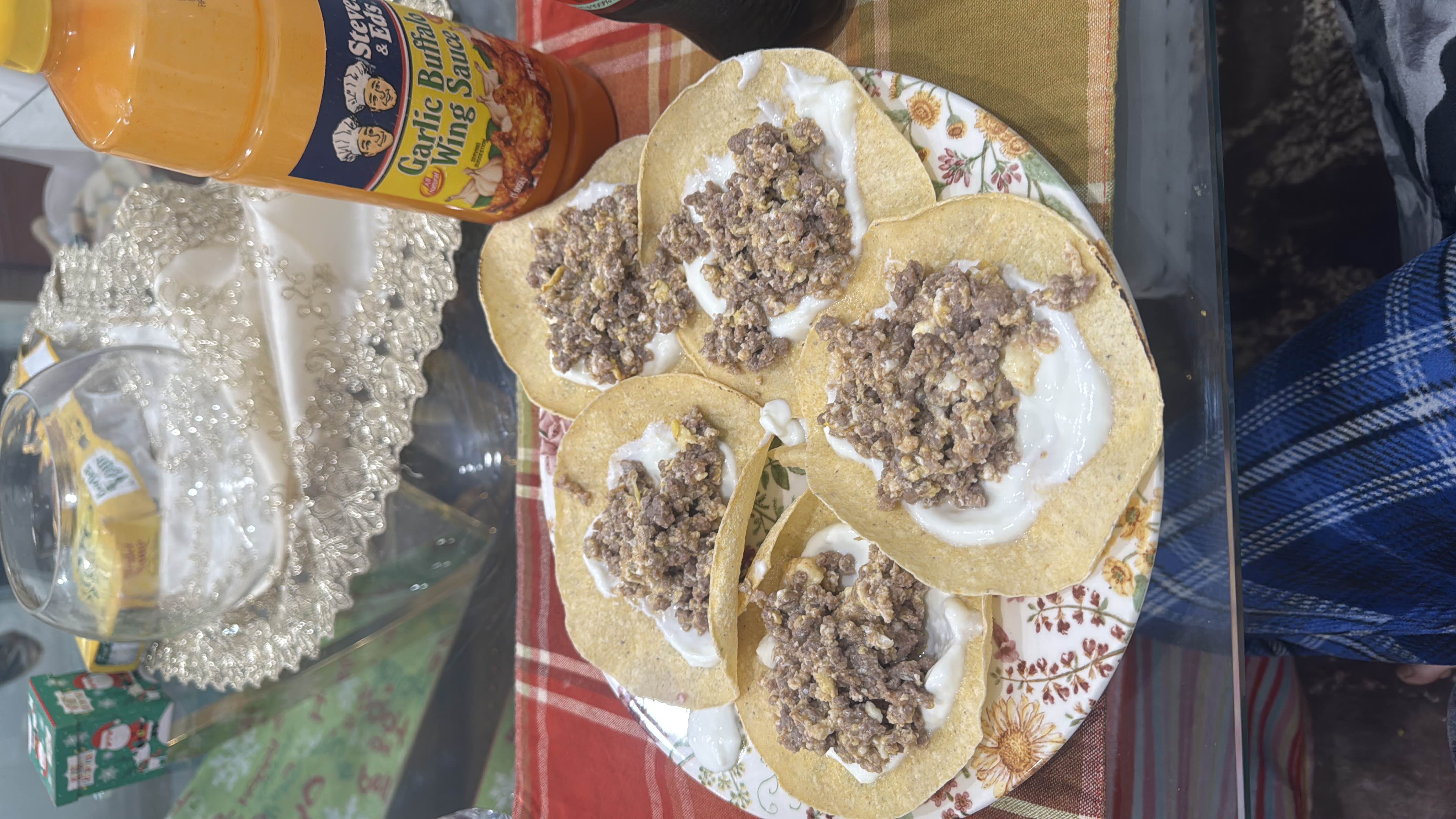 Corn tortillas topped with ground beef and low-fat plain yogurt, served with garlic buffalo wing sauce, eggs, hot sauce, and feta cheese.