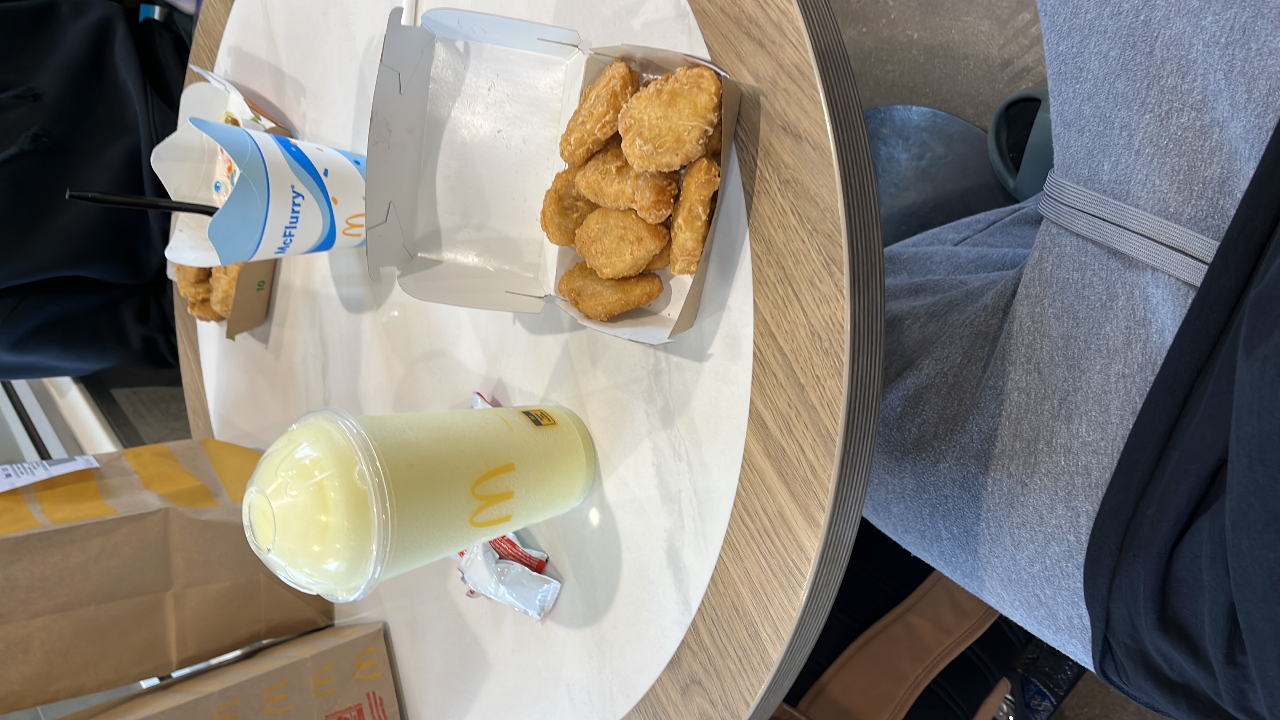 A meal consisting of chicken nuggets, a McFlurry dessert, and a lemonade drink.