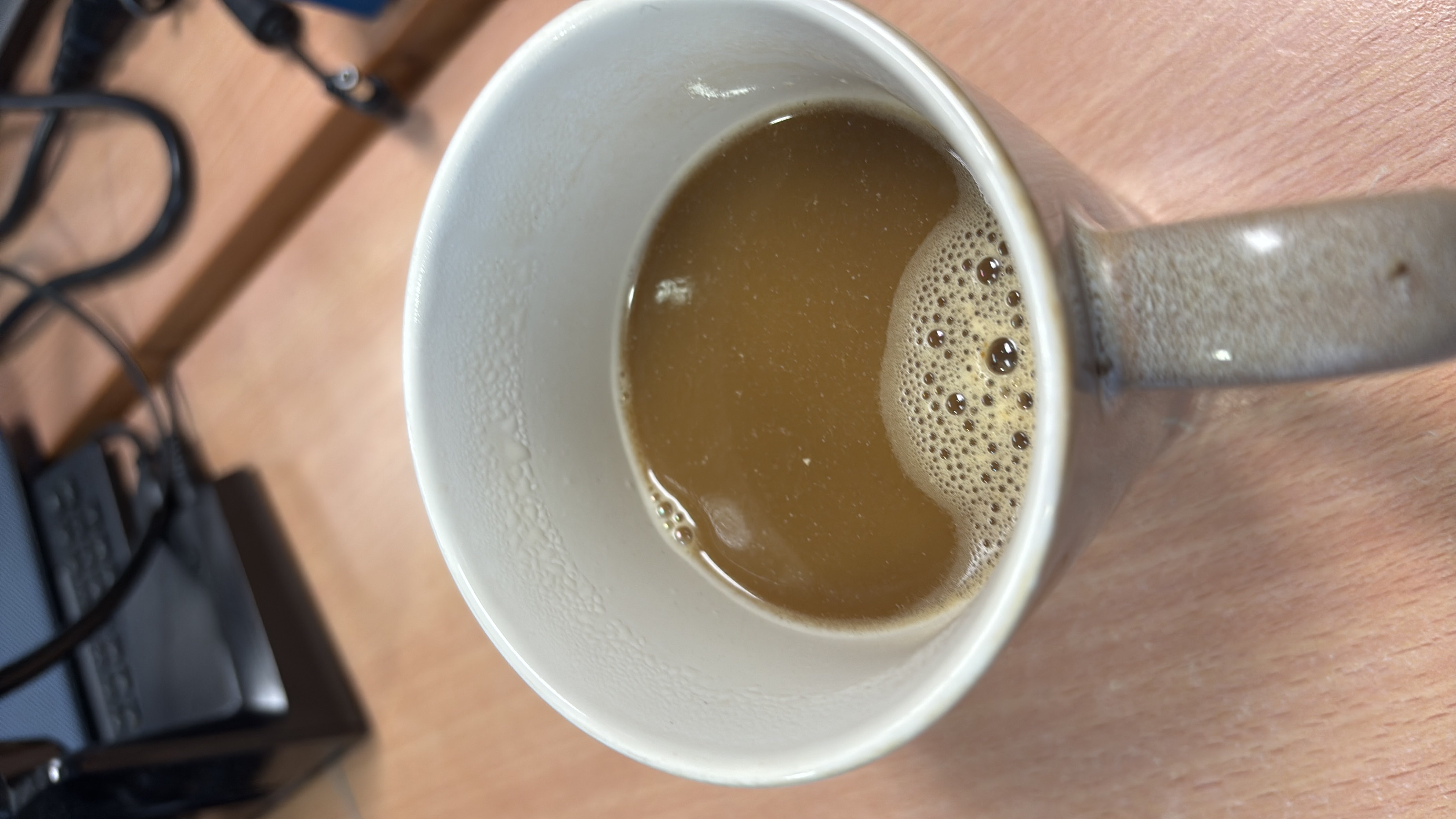 A cup of coffee with milk and sugar, providing a moderate calorie count and a balanced nutritional profile.