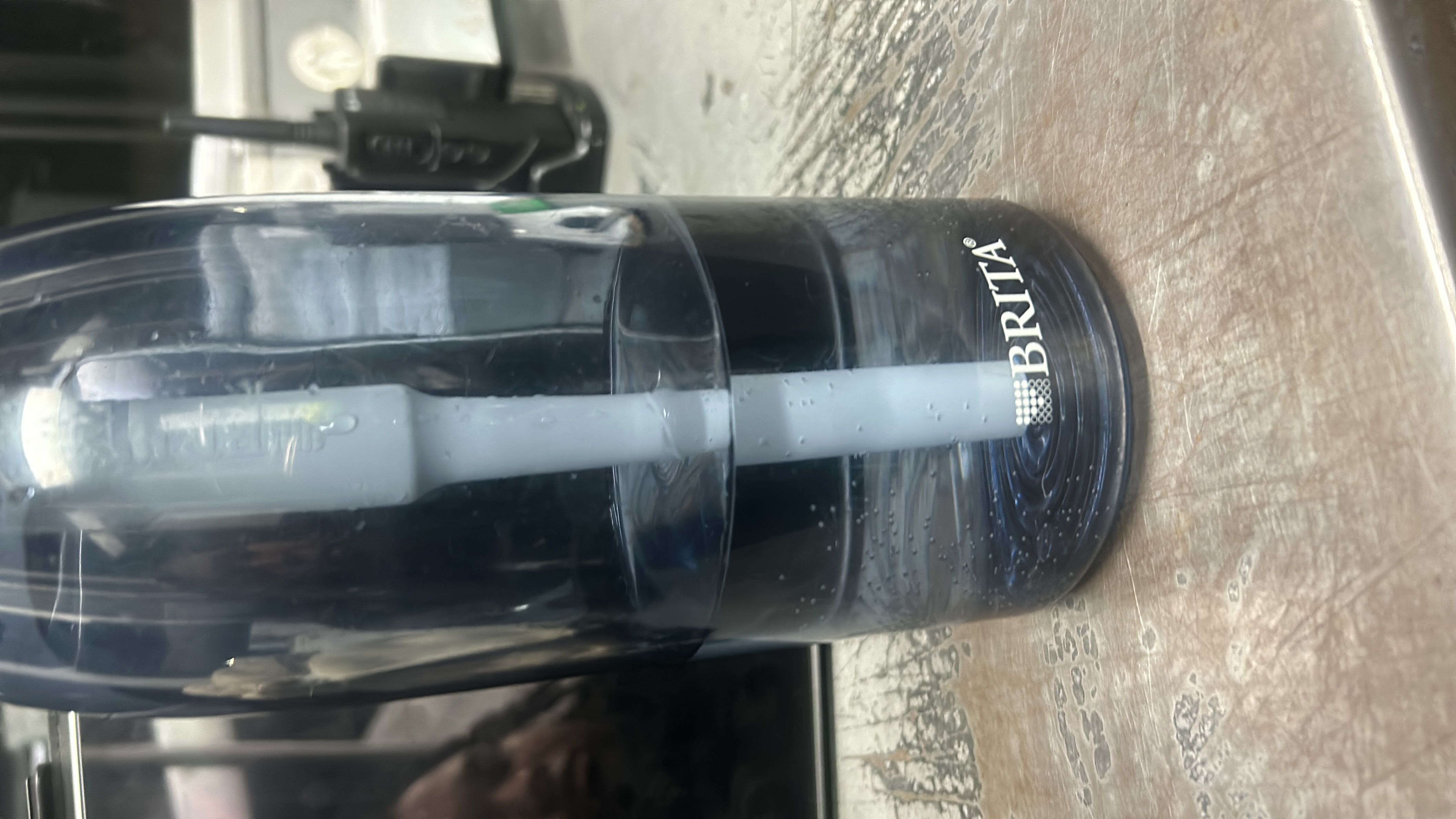 The image shows a Brita water filter bottle containing filtered water, which has no calories, protein, carbs, or fats.