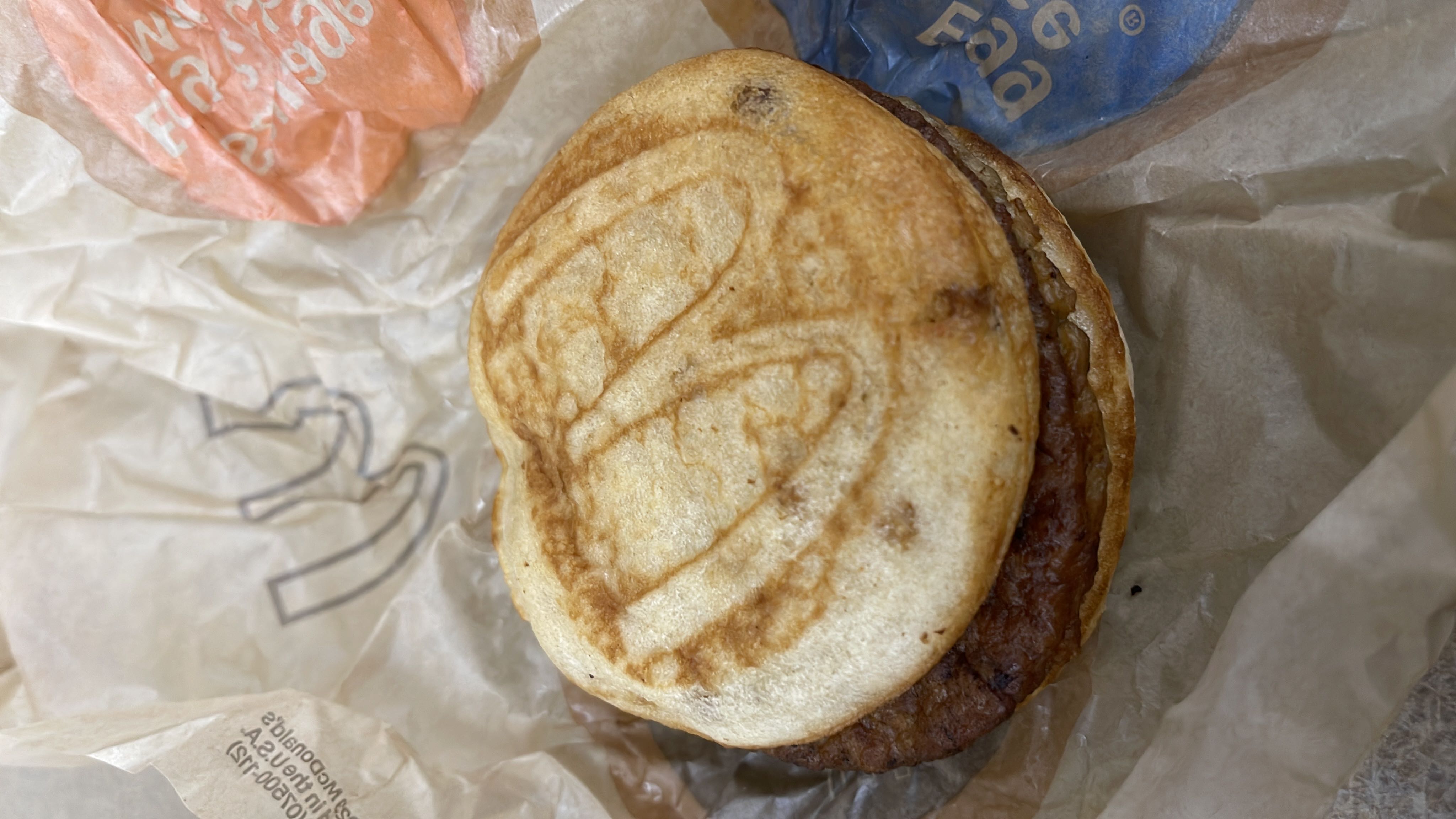 A sausage breakfast sandwich with an English muffin base, providing a balance of protein, carbs, and fats.