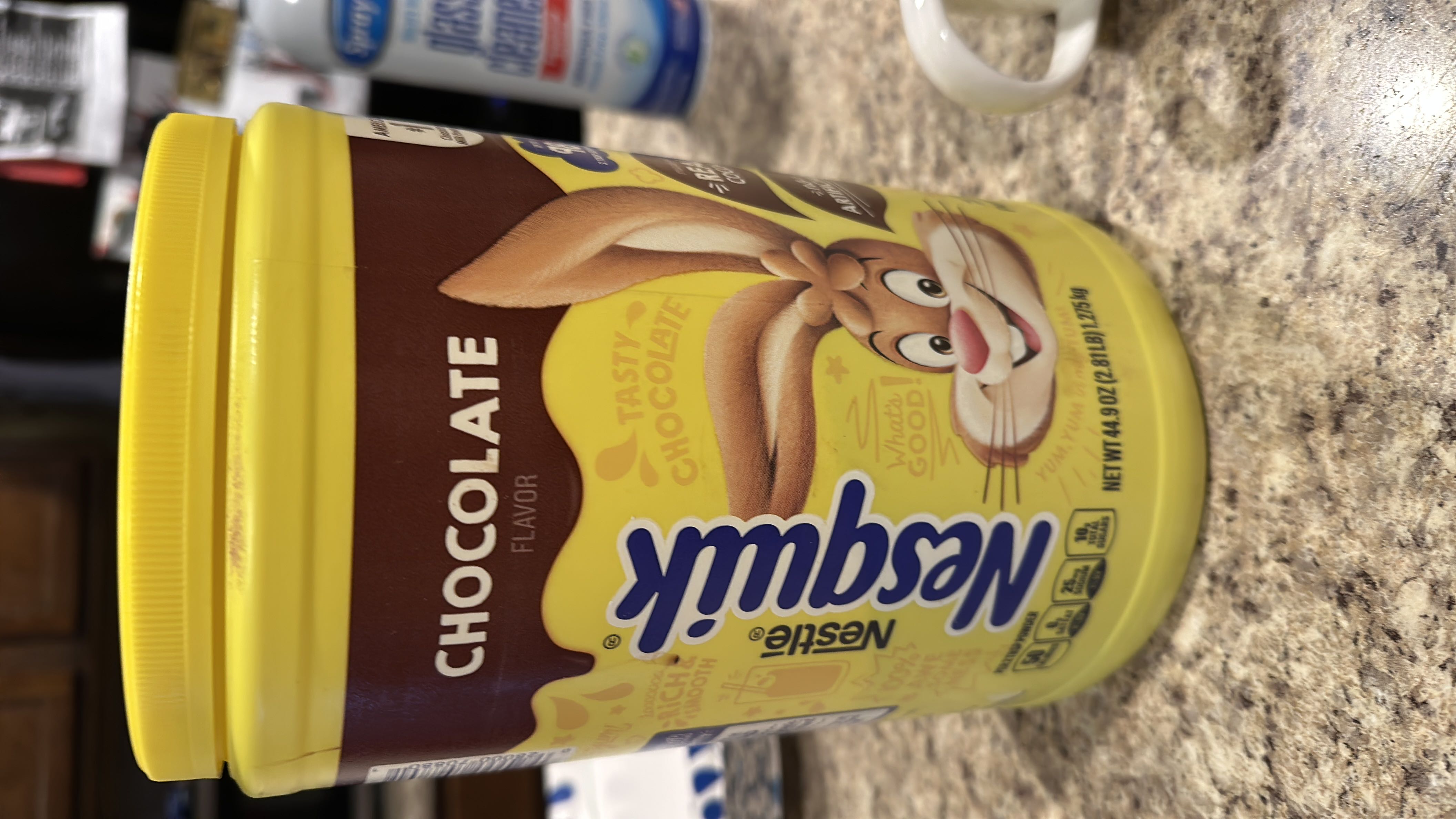 Nestlé Nesquik Chocolate Flavor powder provides 50 calories per serving, with 12g of carbs, 1g of protein, and no fats. It is a chocolate-flavored drink mix with sugar, cocoa, and artificial flavor as key ingredients.