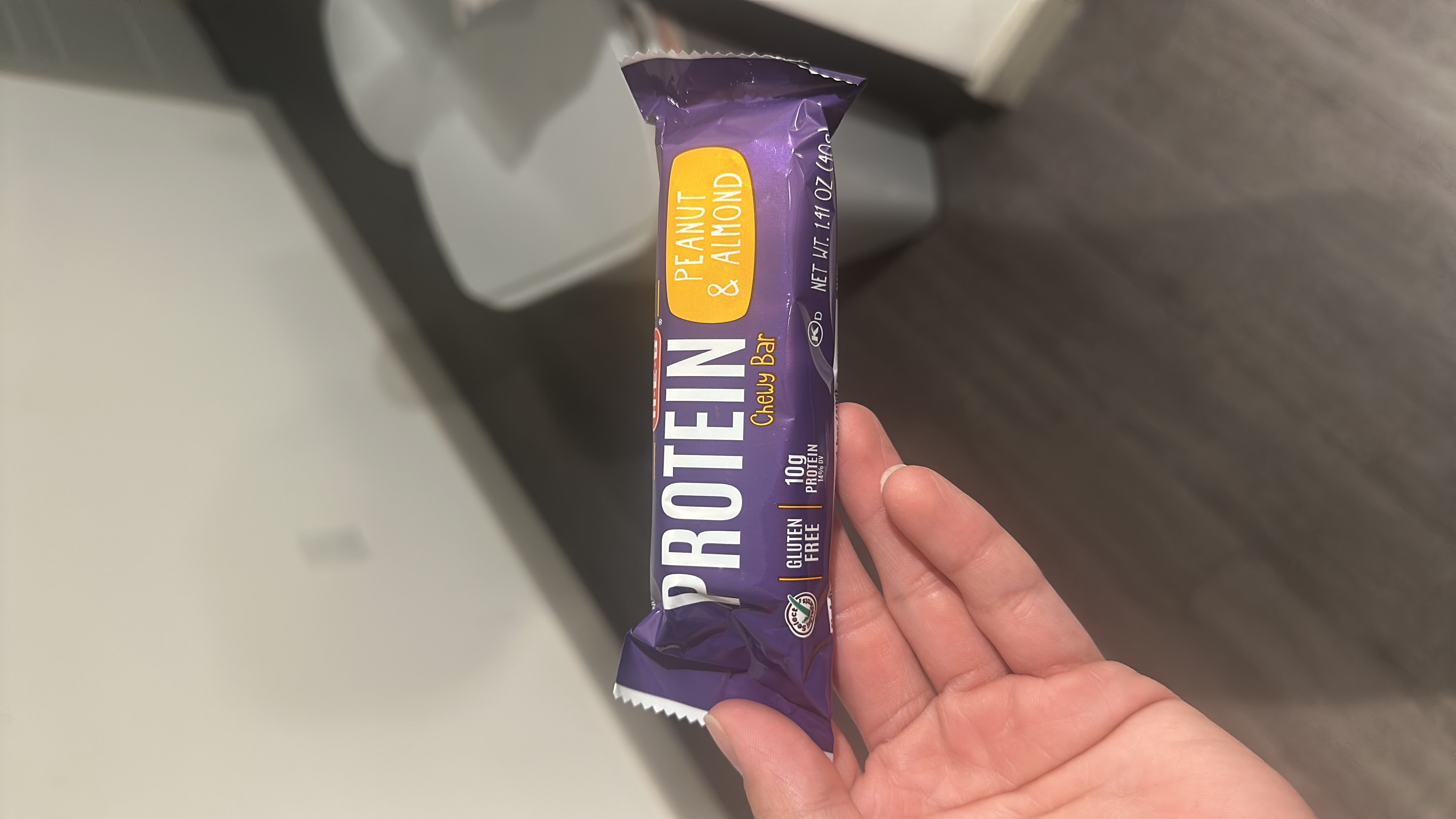A gluten-free protein bar with peanut and almond flavor, providing 10g of protein and 140 calories per serving.