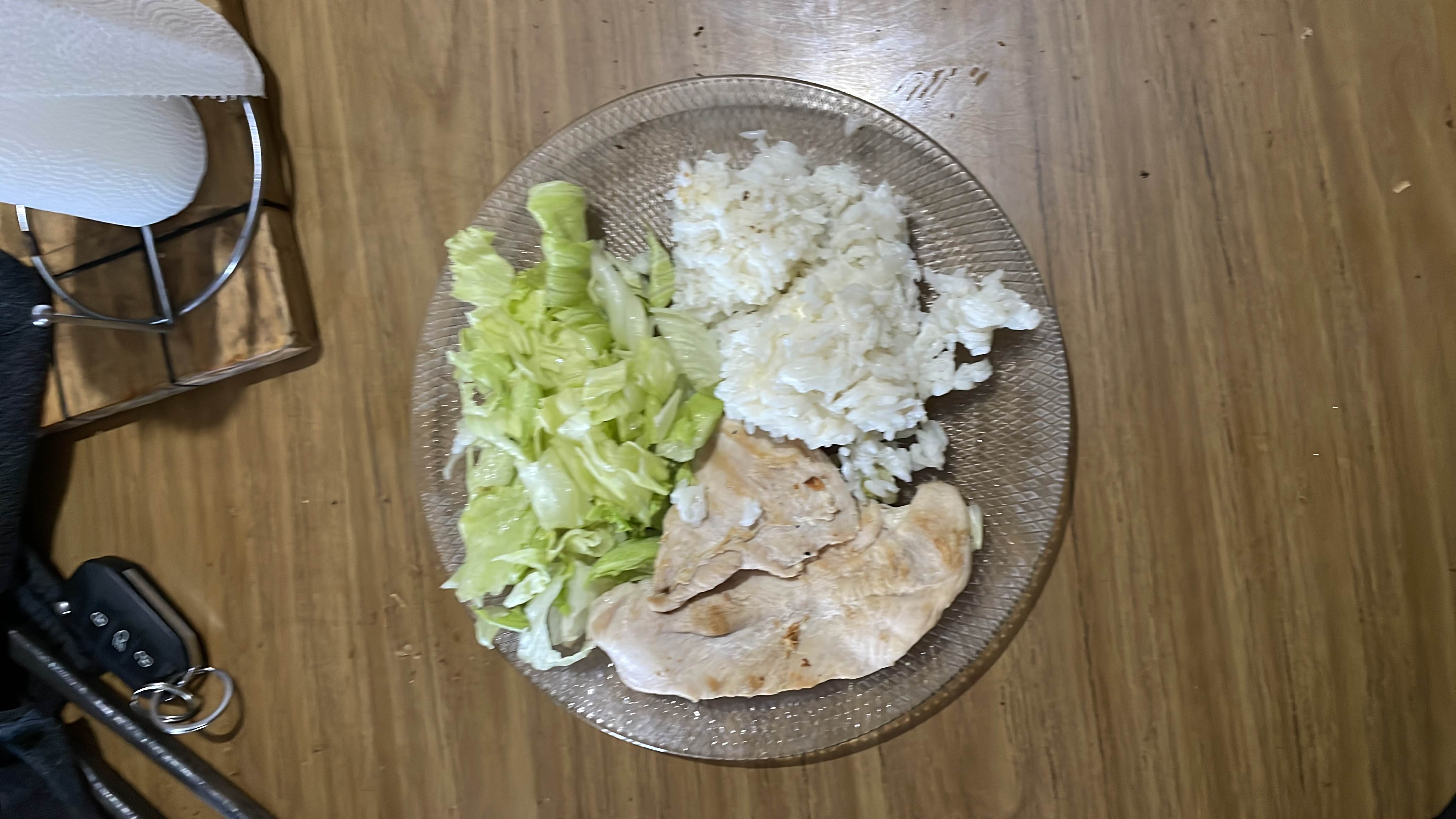 A balanced meal consisting of grilled chicken breast, white rice, and lettuce, providing a good mix of protein, carbohydrates, and minimal fats.