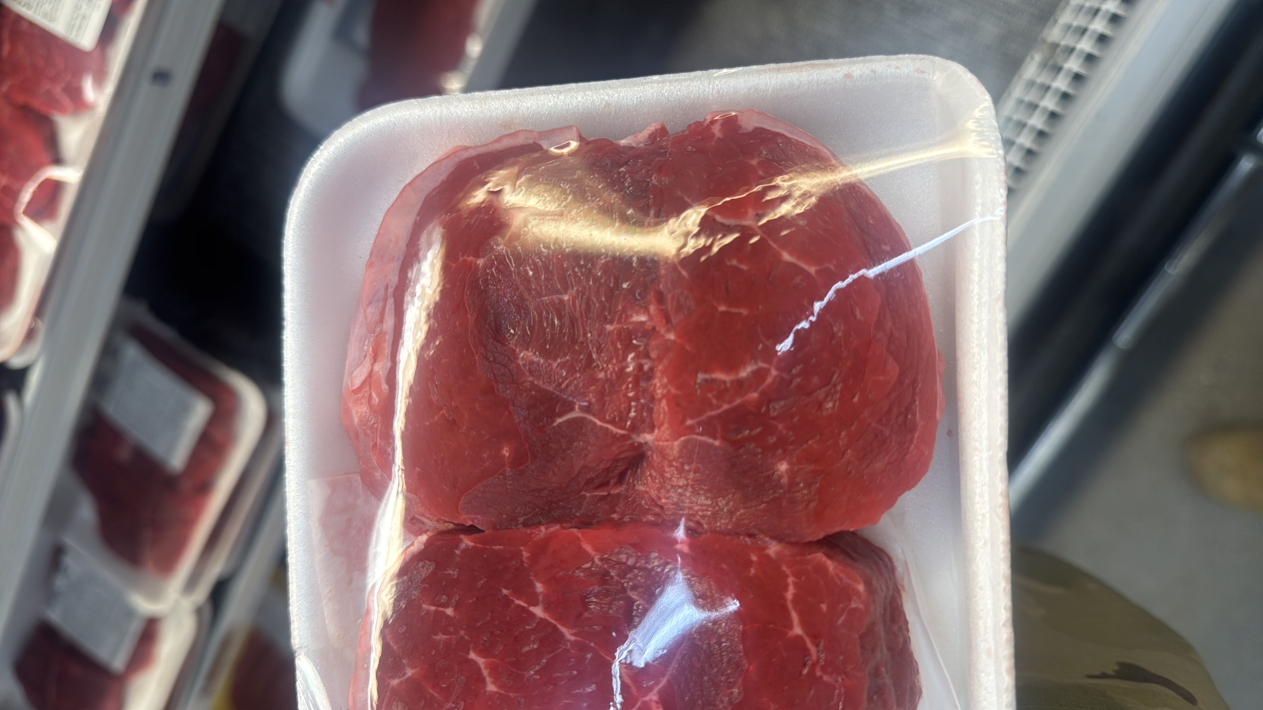 This is a packaged portion of raw beef, a high-protein and high-fat food with no carbohydrates.