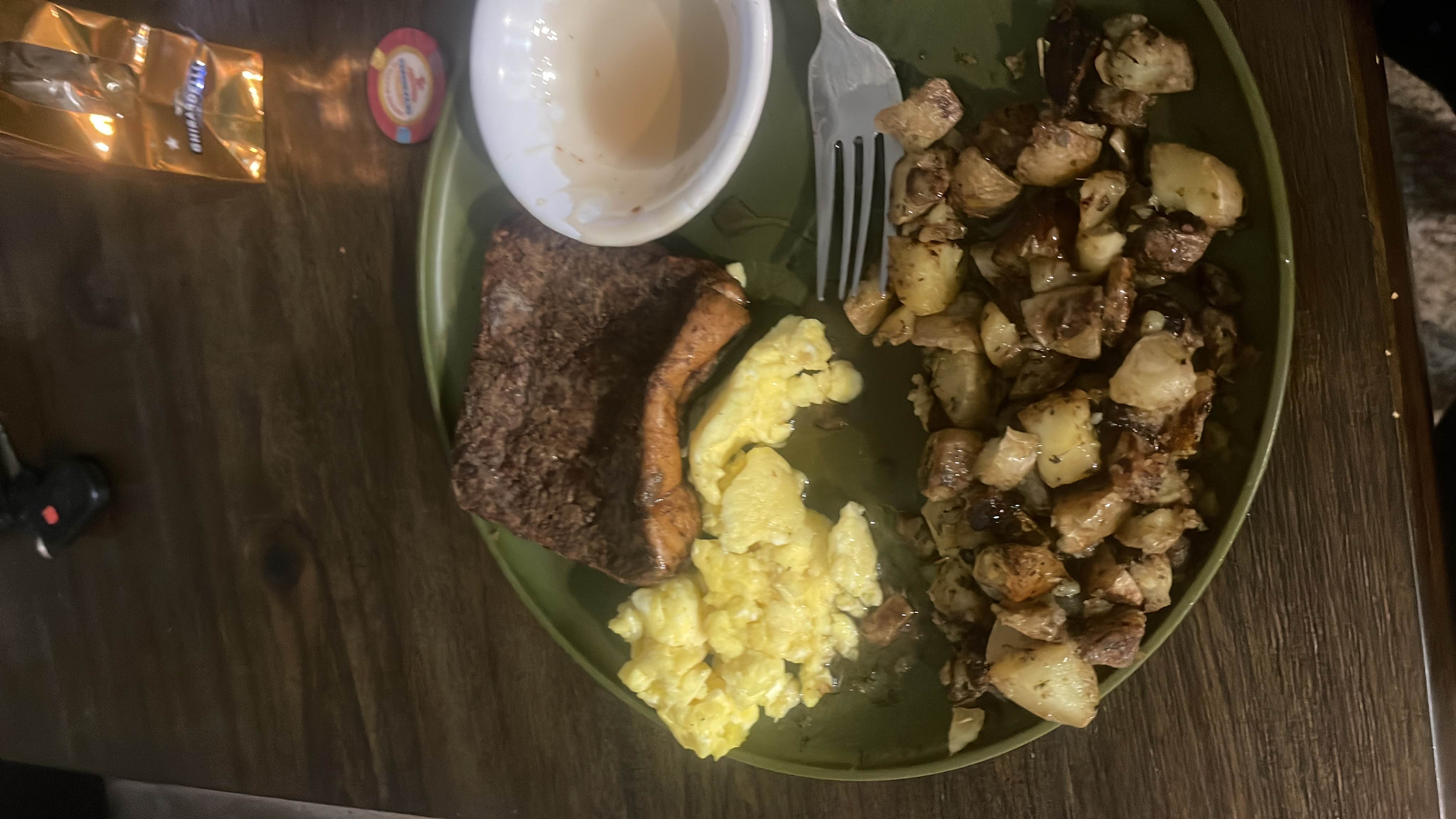 A meal consisting of salmon, scrambled eggs, and roasted potatoes, providing a balanced mix of protein, carbs, and fats.