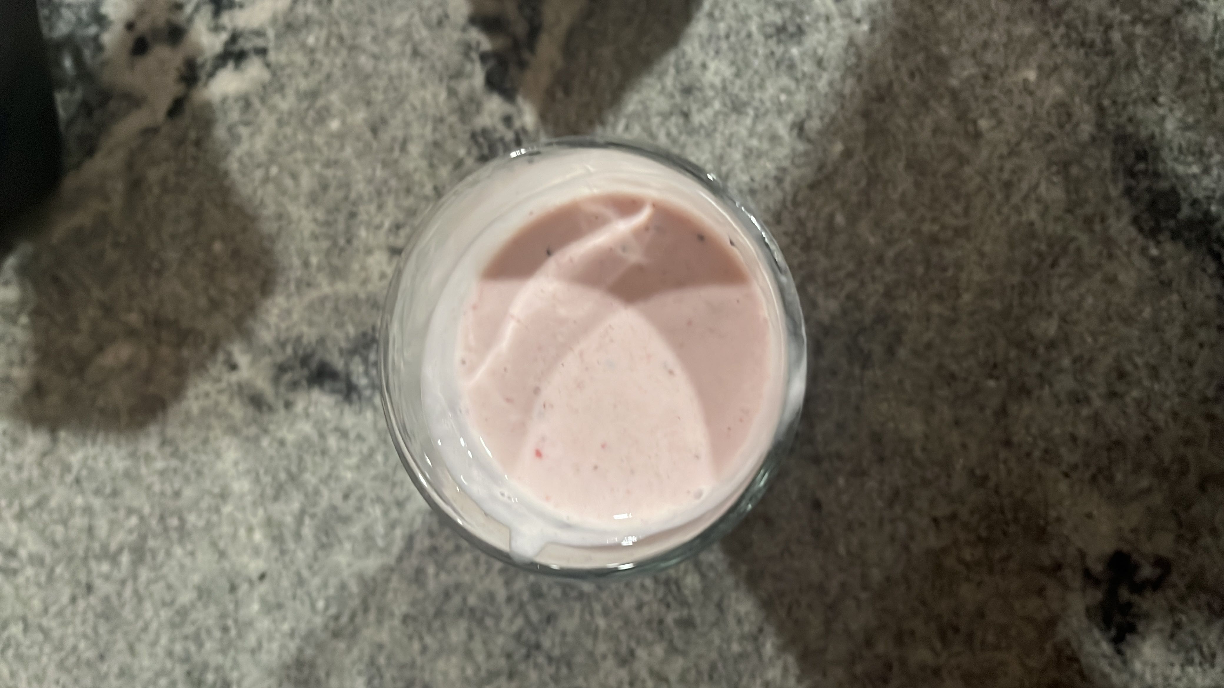 A creamy strawberry yogurt smoothie, high in protein and carbs, with a moderate fat content.