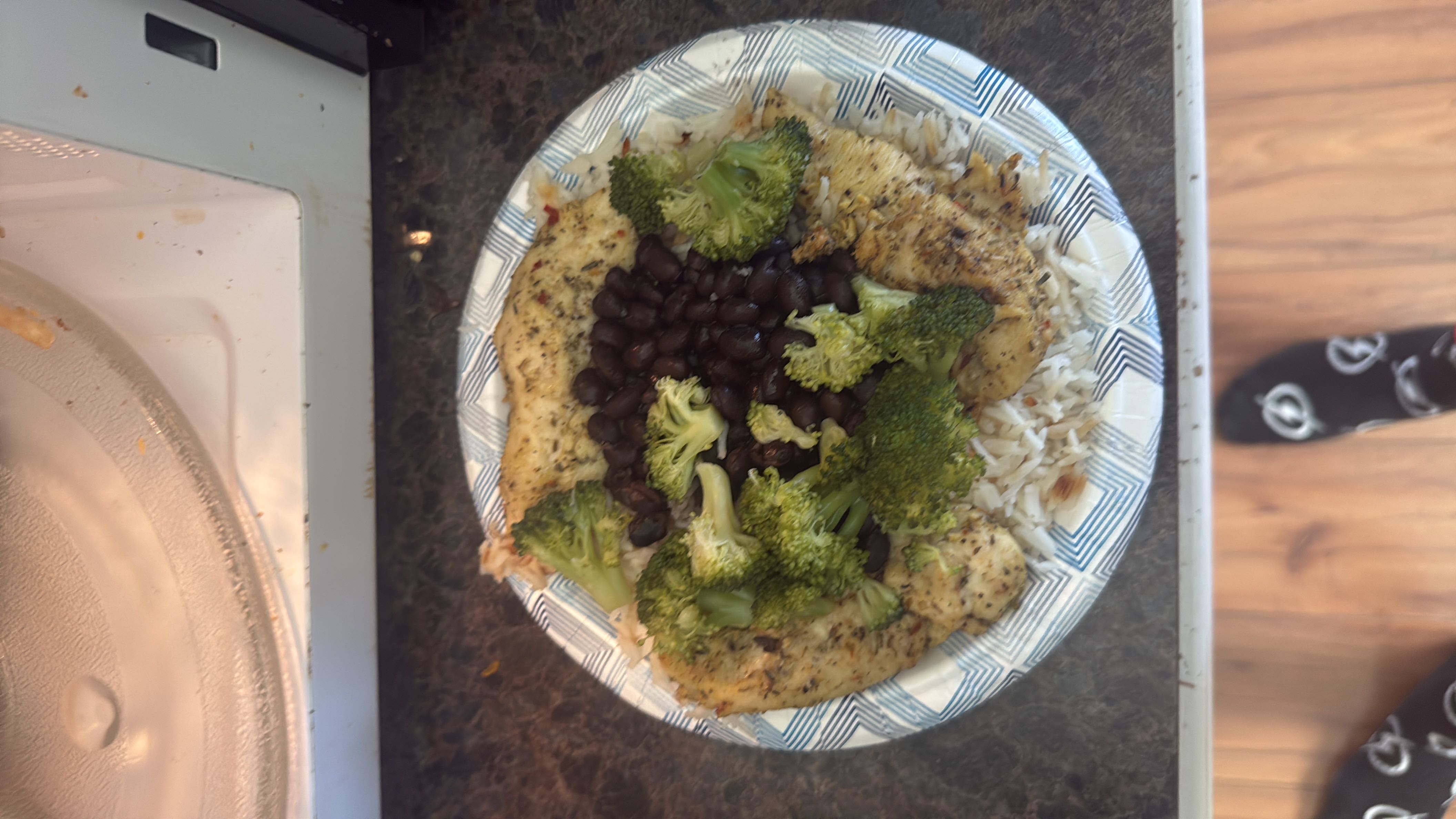 A balanced meal consisting of chicken, broccoli, black beans, and rice, providing a good mix of protein, carbs, and fiber.