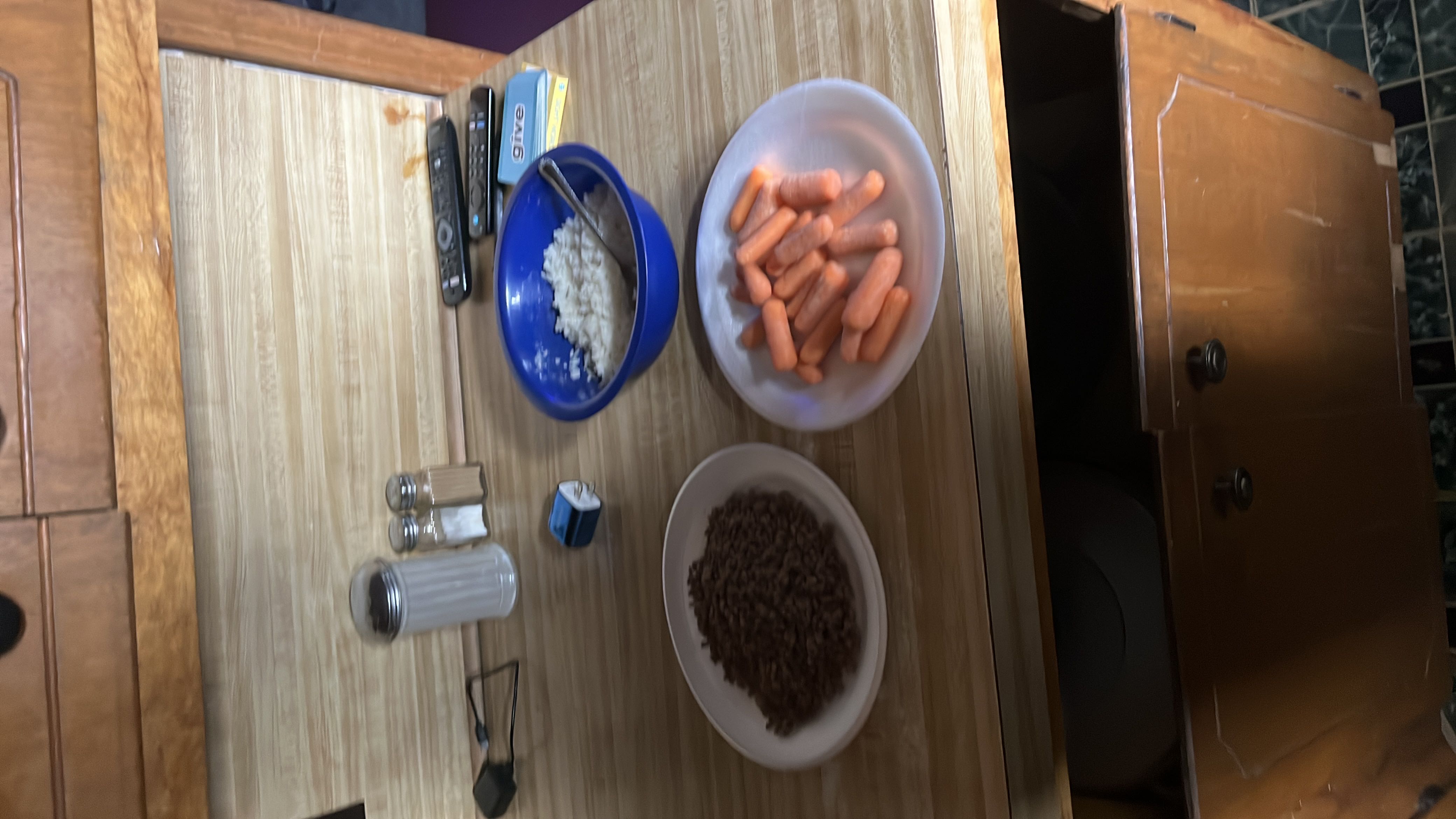 A meal consisting of ground beef, white rice, and baby carrots, providing a balanced mix of protein, carbohydrates, and fiber.