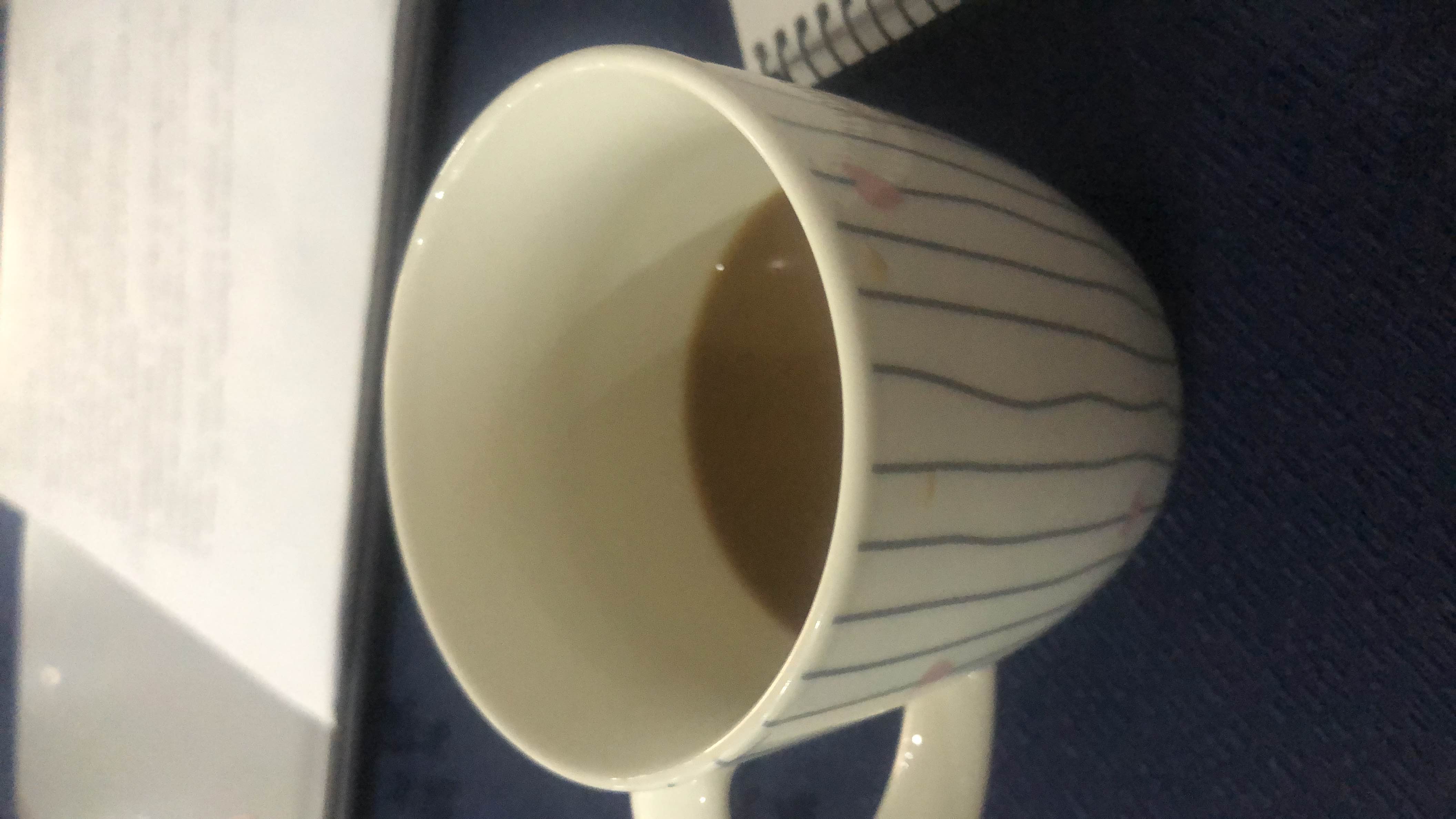 A cup of coffee with milk and sugar, providing a moderate calorie count and a balanced nutritional profile.