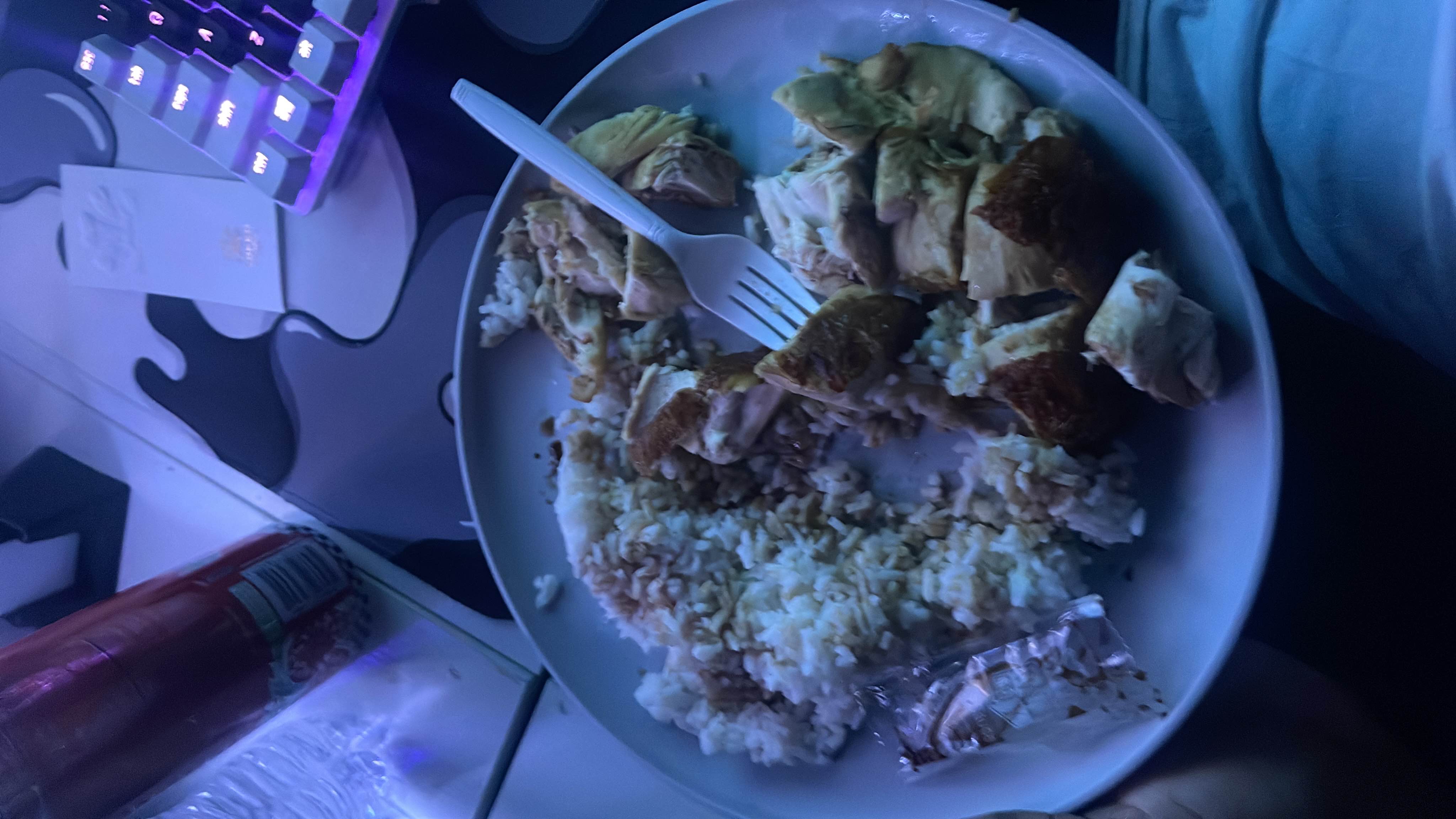 A plate containing chicken and rice, likely seasoned with soy sauce, providing a balanced meal with moderate protein and carbohydrates.