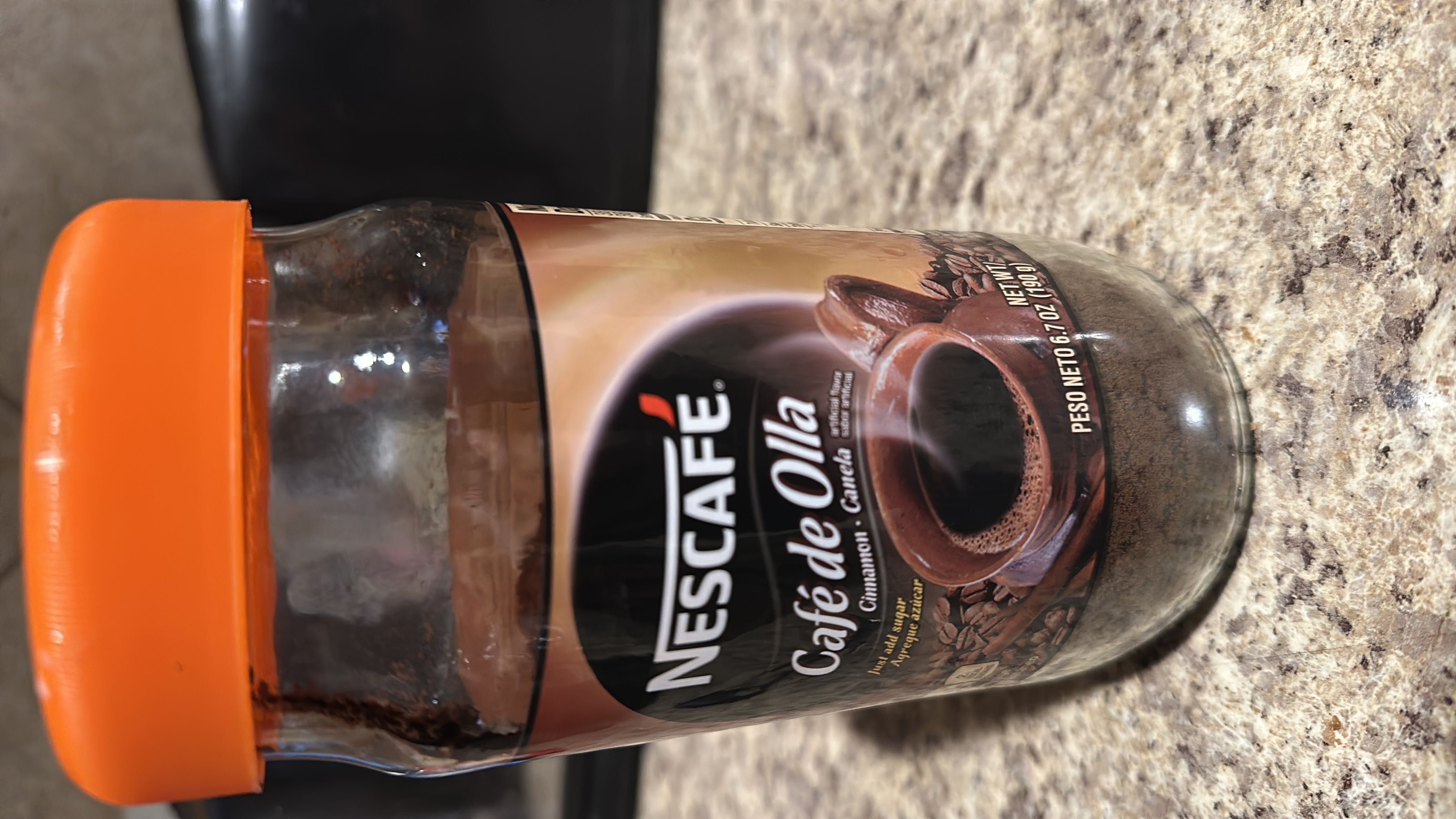 Nescafé Café de Olla is an instant coffee with cinnamon flavor, containing no calories, protein, carbs, or fats per serving.