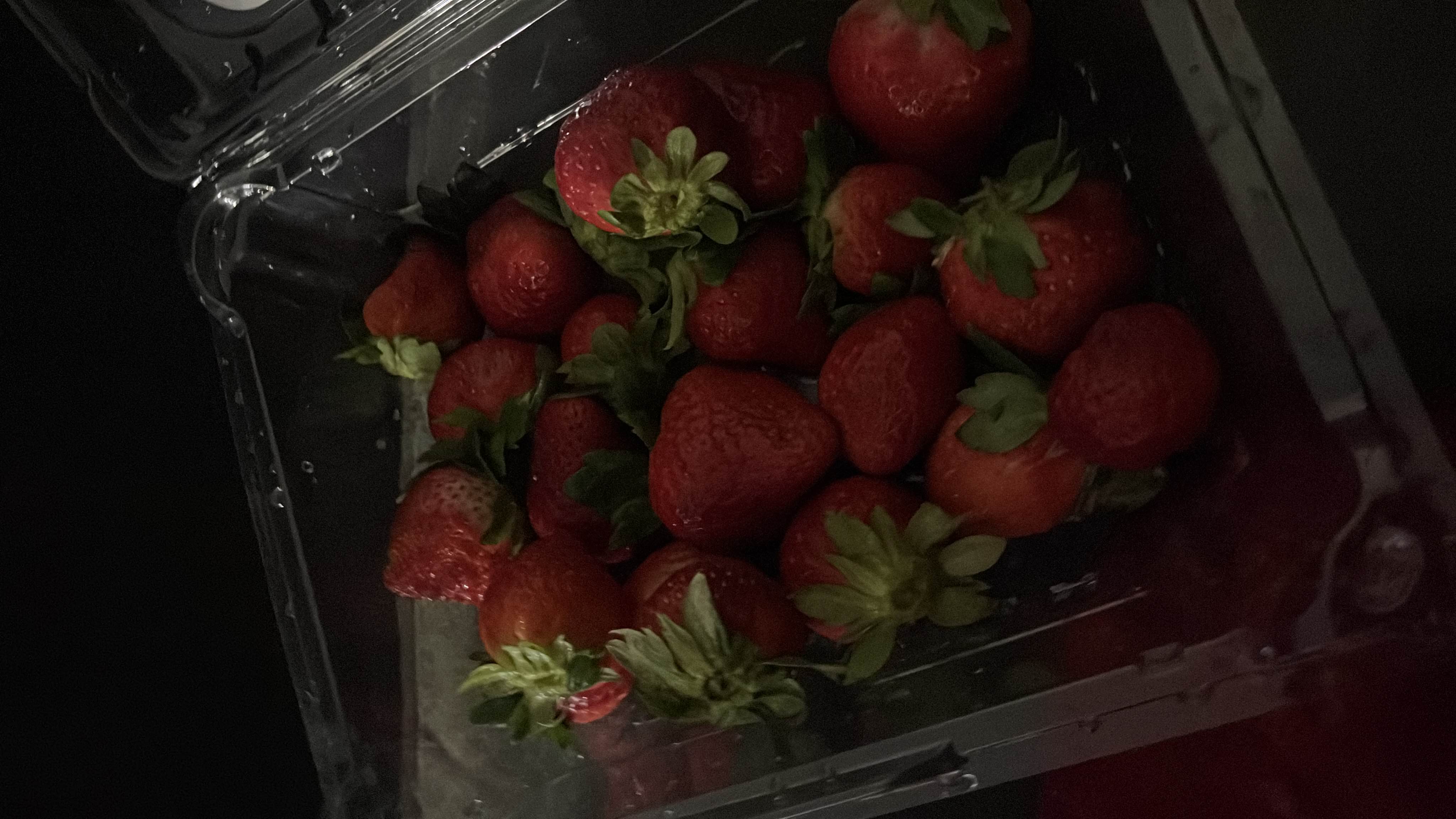 The image shows fresh strawberries, which are low in calories, high in vitamin C, and a healthy snack option.