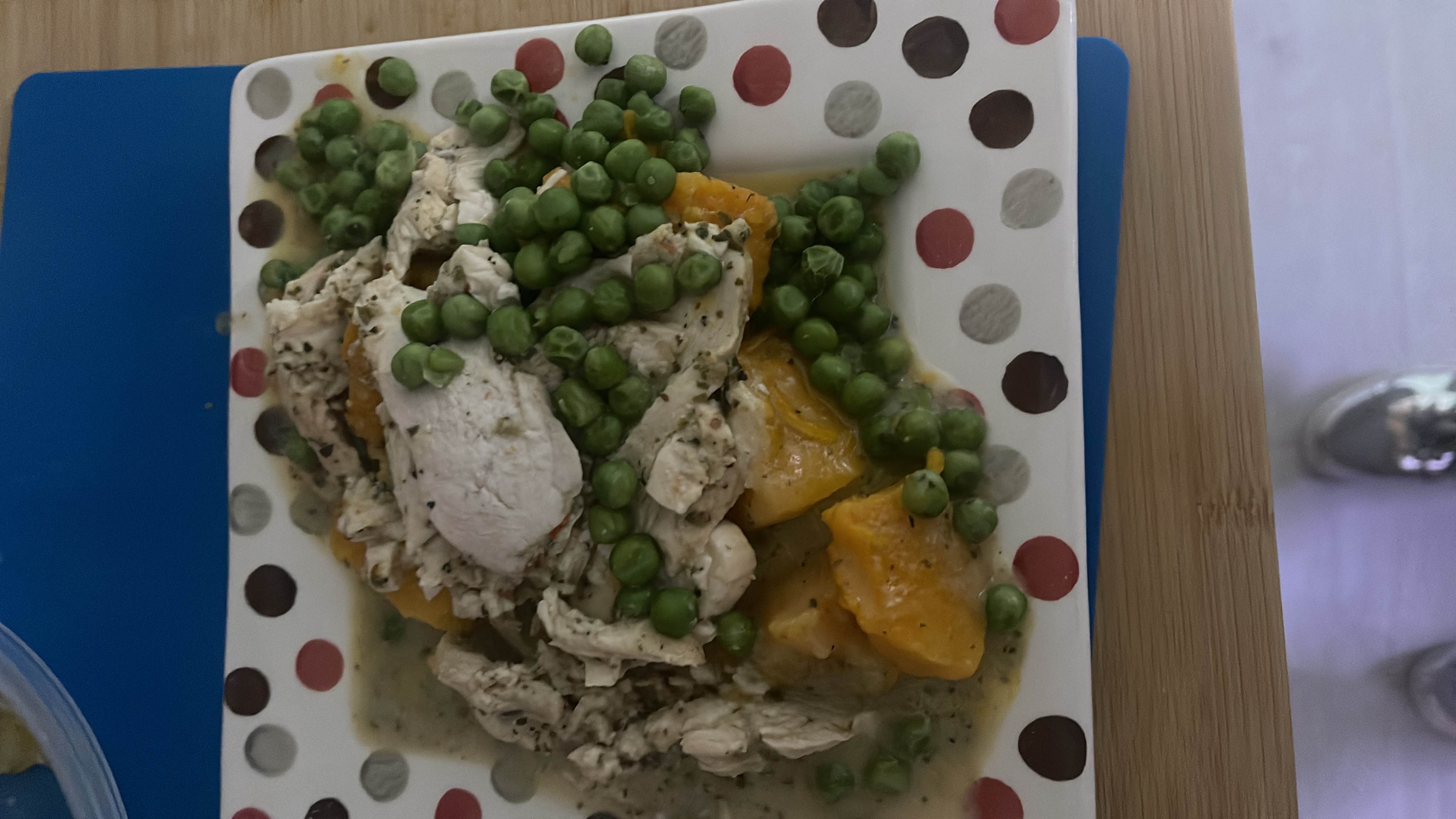 A healthy dish consisting of chicken breast, peas, and butternut squash, providing a balanced mix of protein, carbs, and fats.