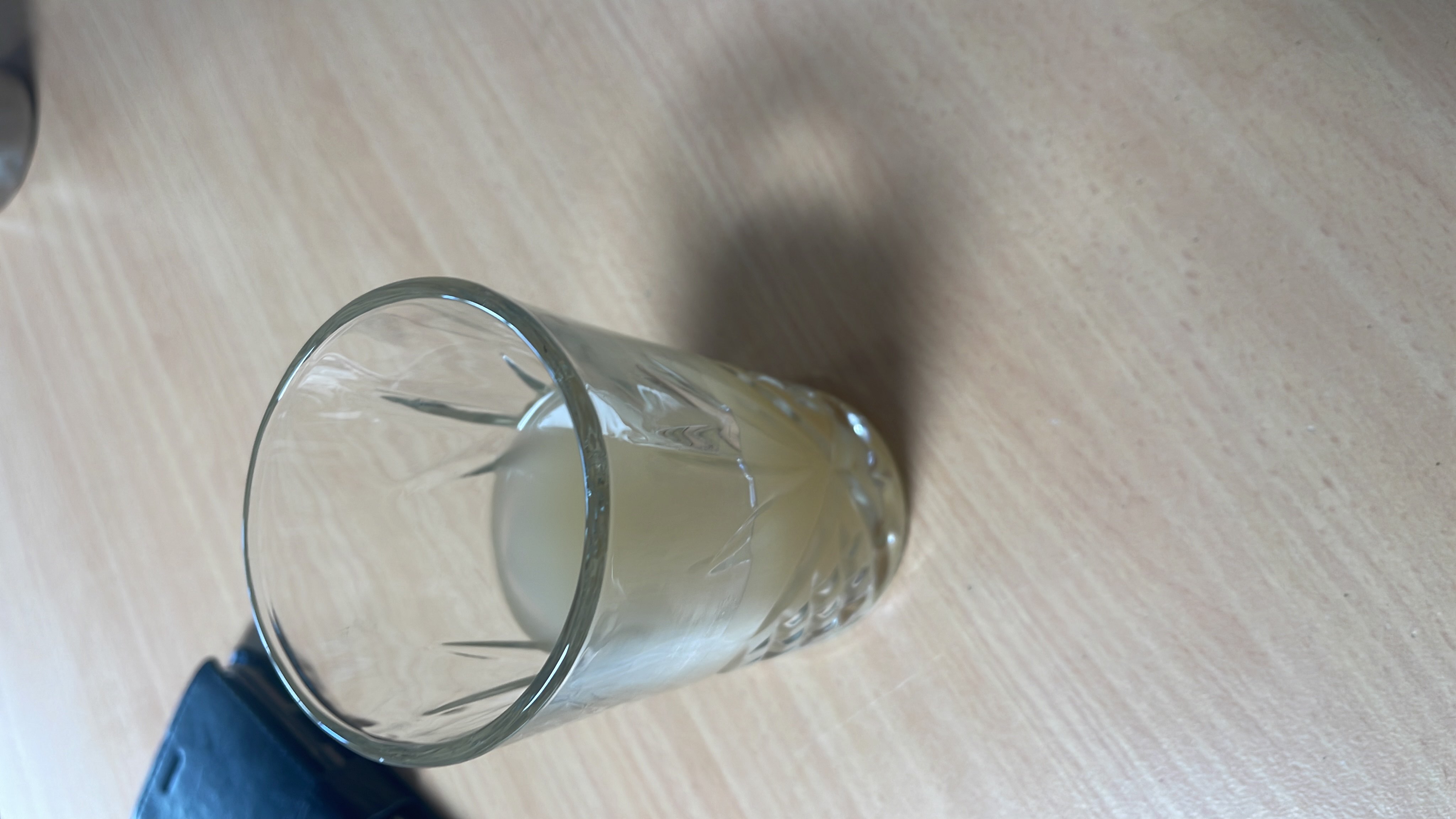 A small glass of lemon juice with added sugar, providing a light and refreshing beverage.