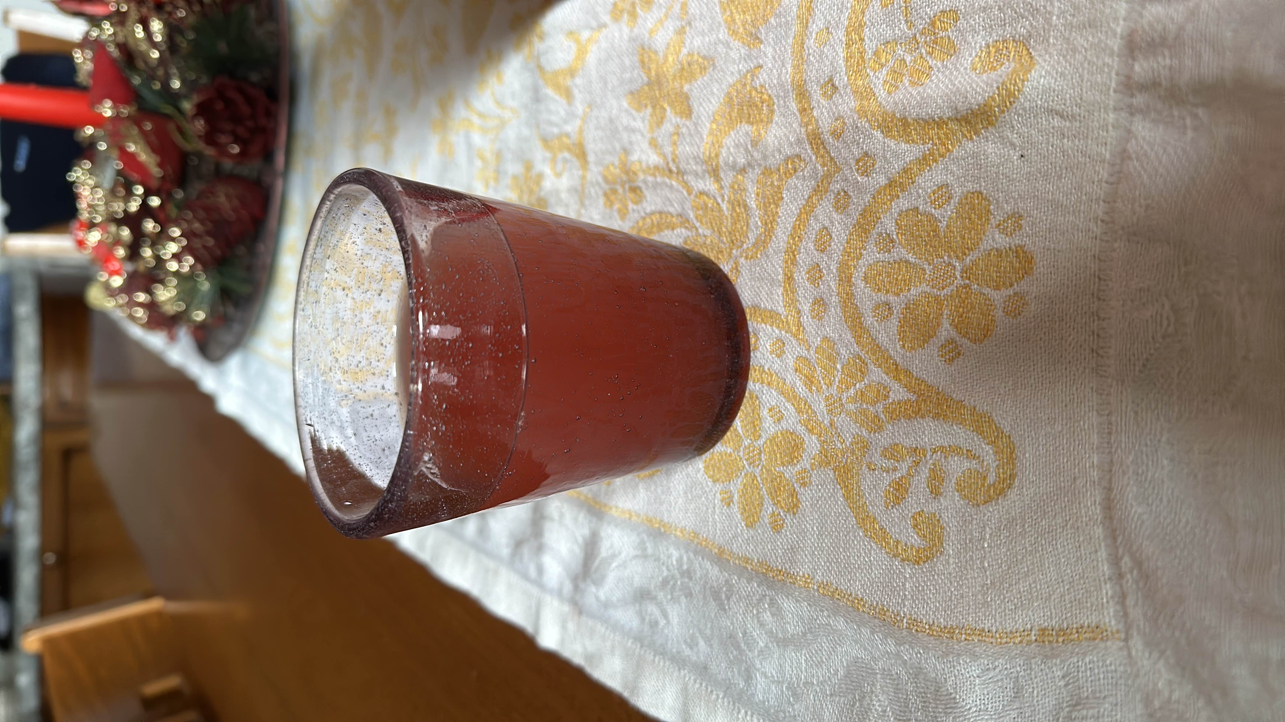 A small glass of cranberry juice, low in calories and fats, with a moderate amount of carbohydrates.