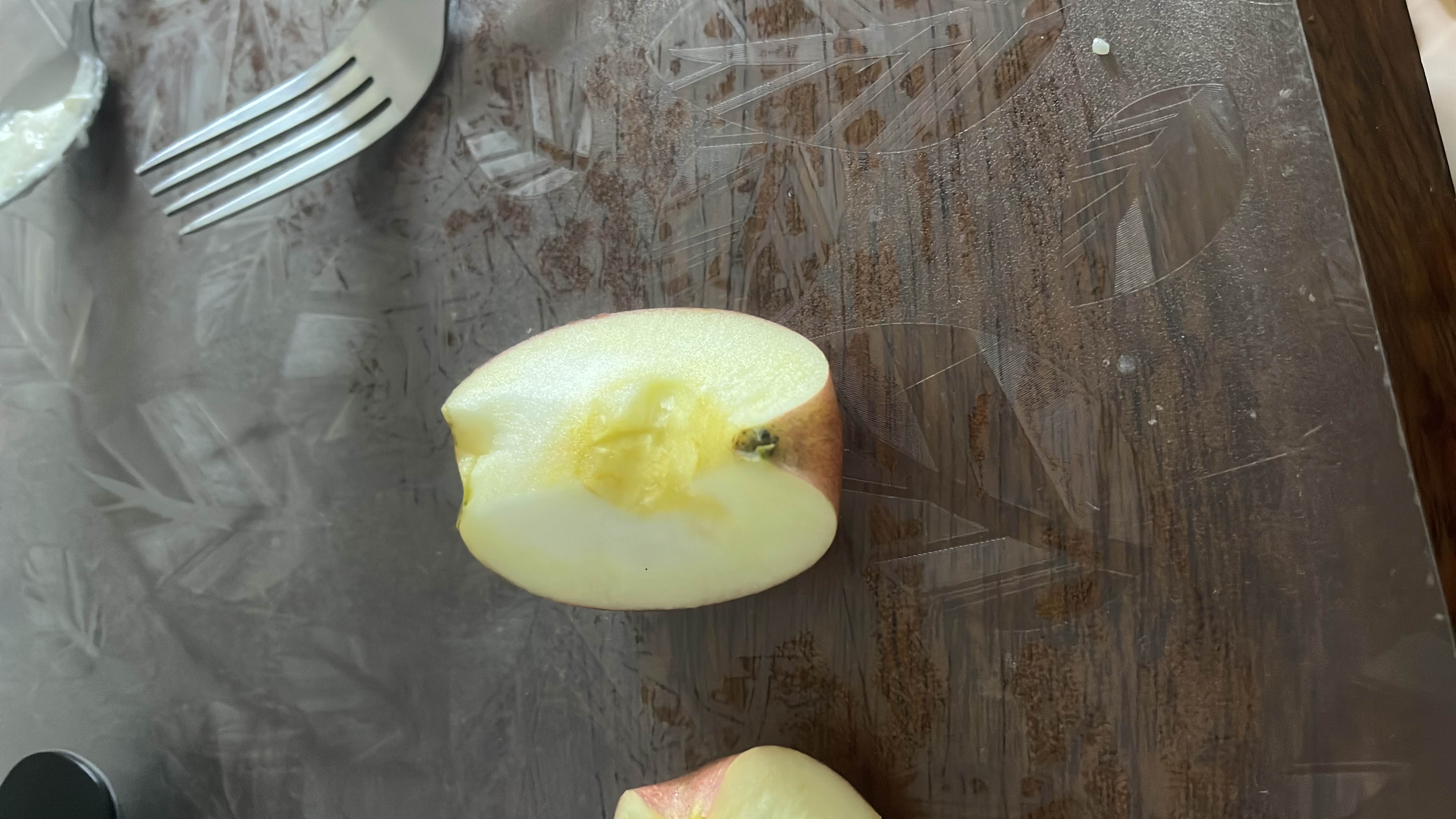The image shows a halved apple, which is a low-calorie fruit rich in carbohydrates and fiber, making it a healthy snack option.