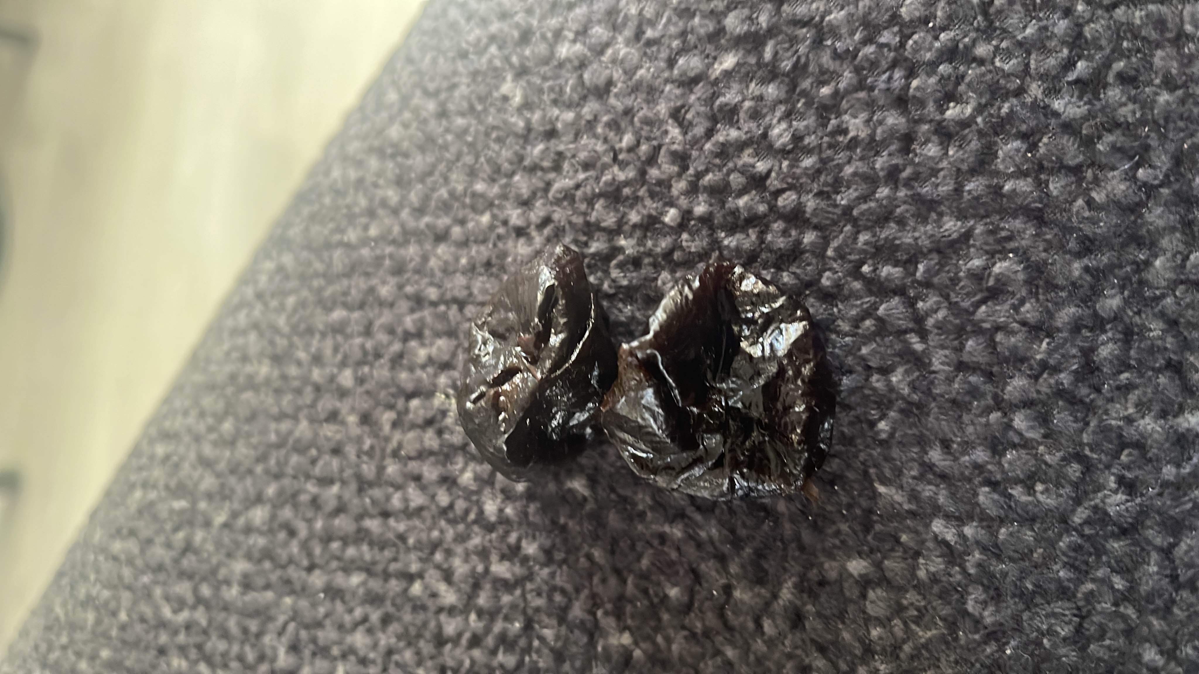 The image shows dried prunes, which are a nutrient-dense snack high in carbohydrates and low in fats and protein.