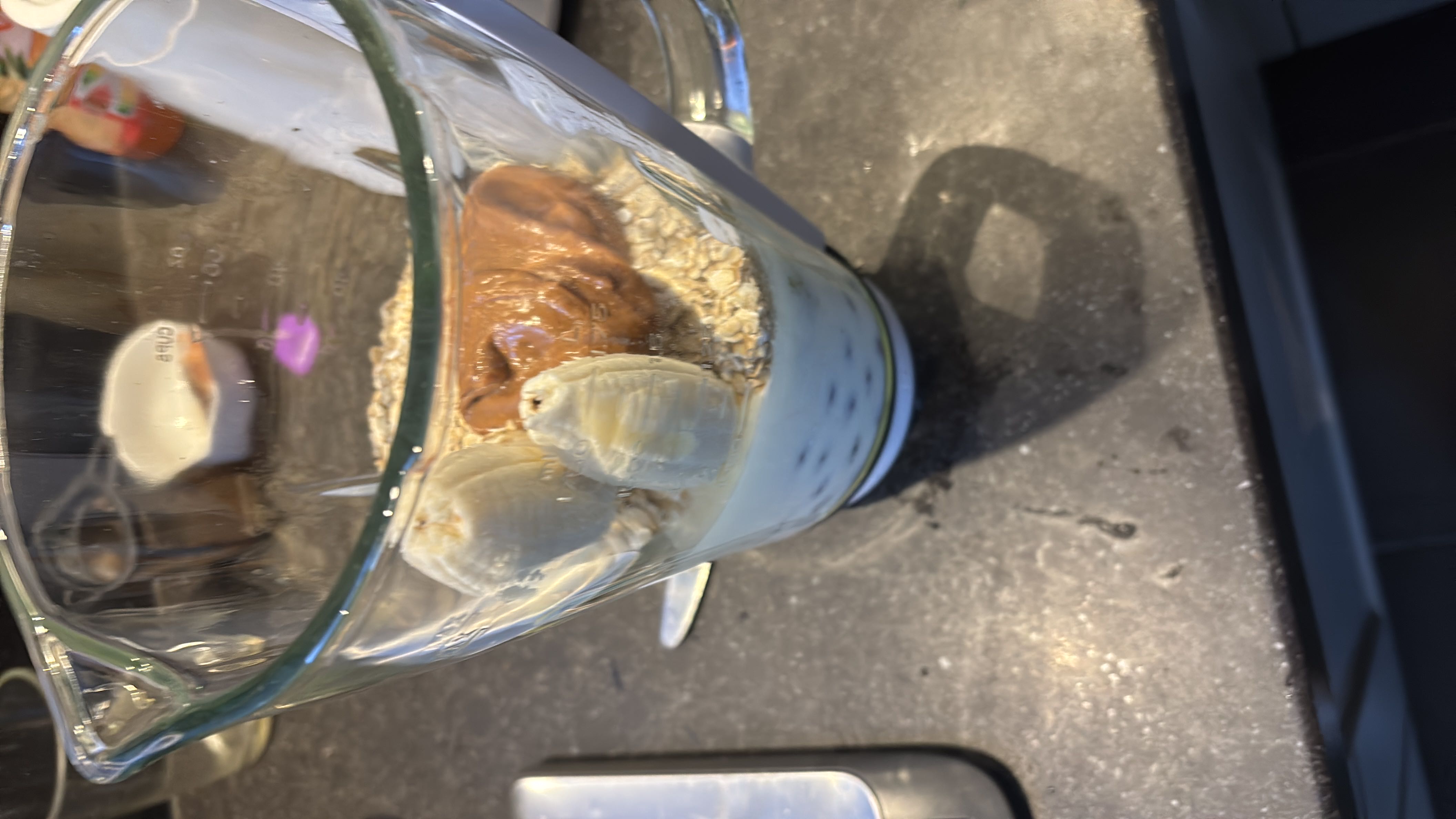 A nutritious blend of frozen blueberries, kefir made with full milk, bananas, peanut butter, fine oats, and kiwi, ideal for a healthy breakfast or snack.