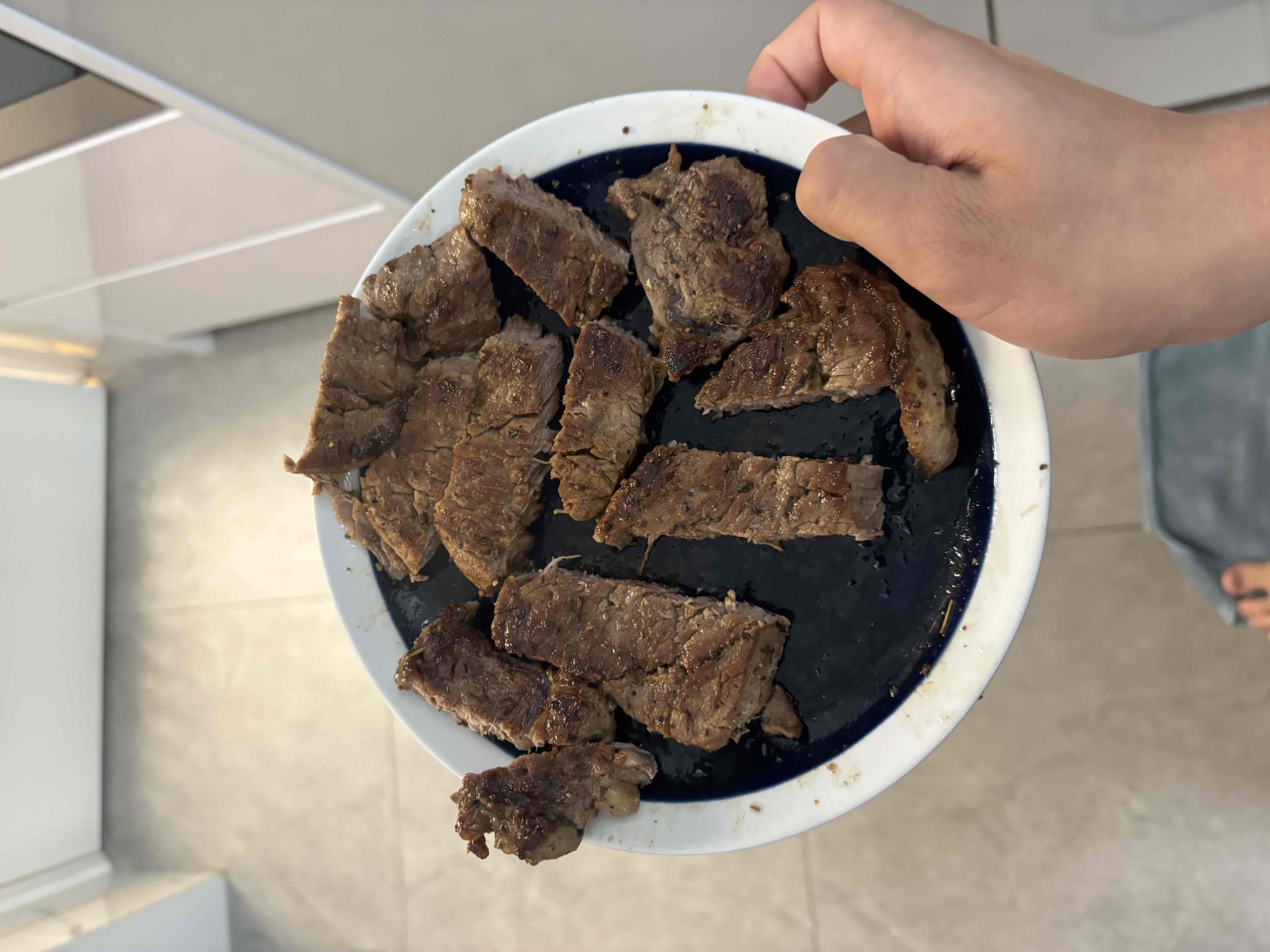 Cooked slices of beef steak, offering a high-protein meal with moderate fat content.