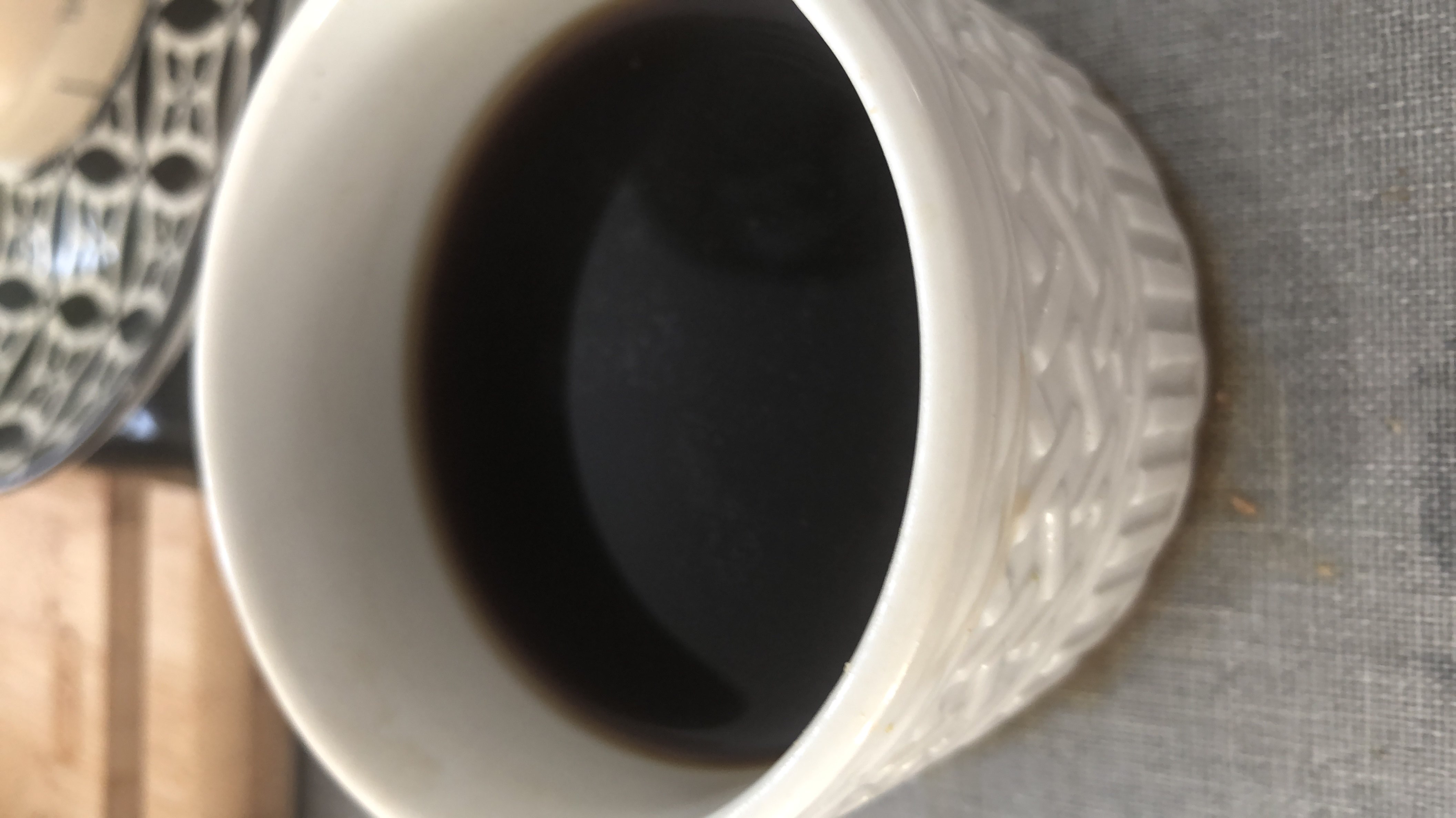 A cup of plain black coffee with minimal calories and negligible nutrients.
