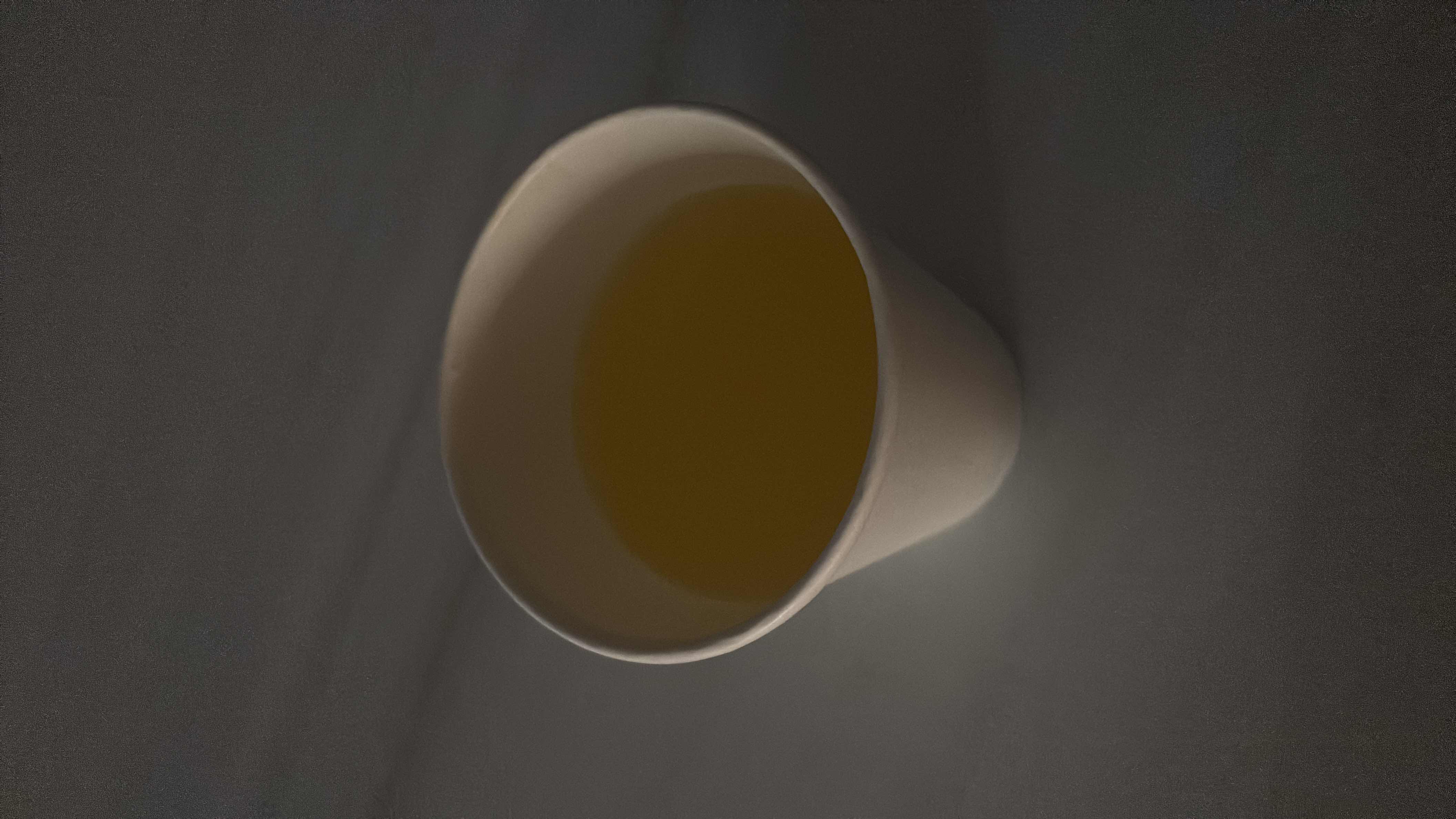 A small cup of pale-colored tea with minimal caloric content.