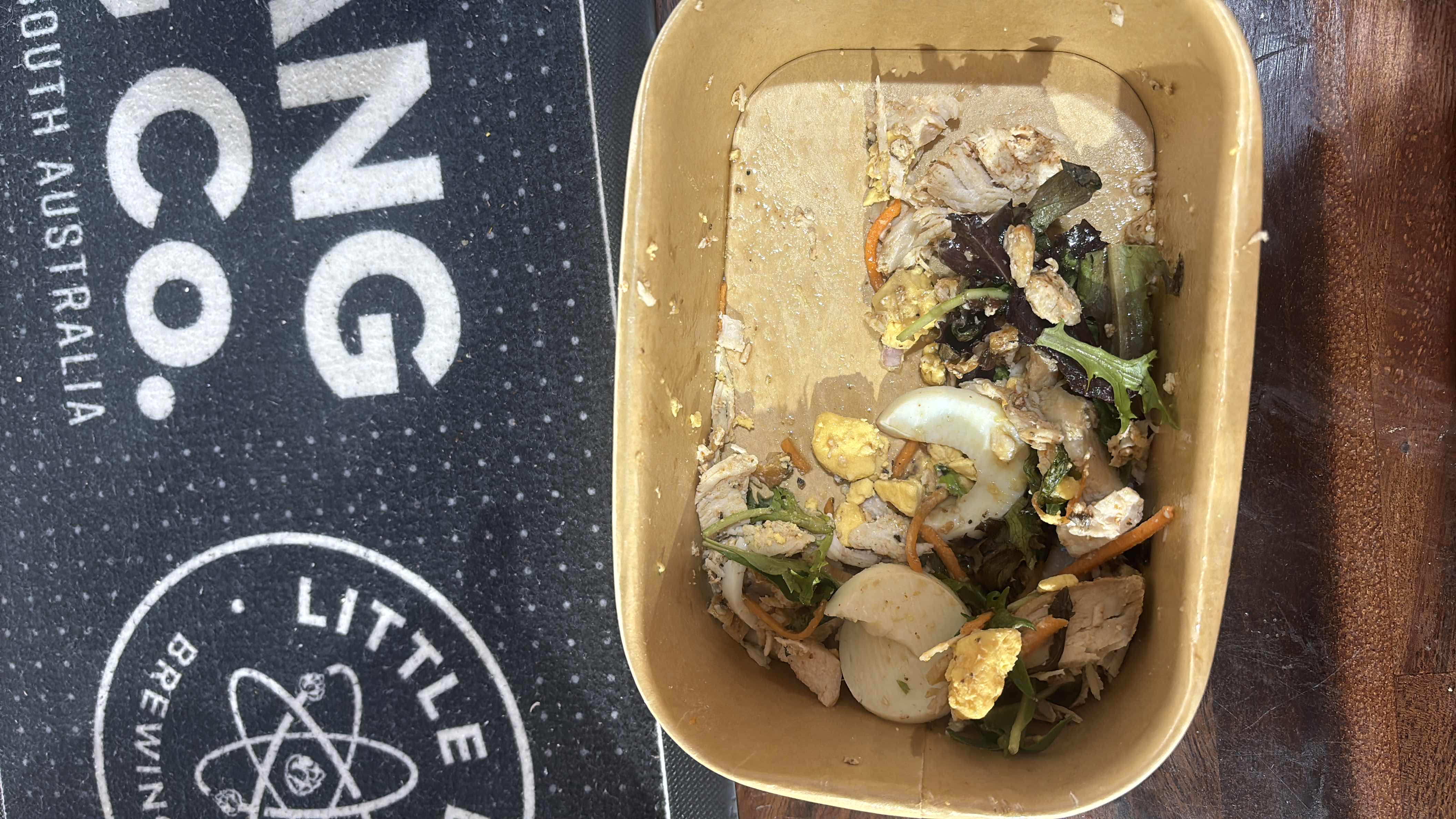 A leftover salad with chicken, egg, and mixed greens.