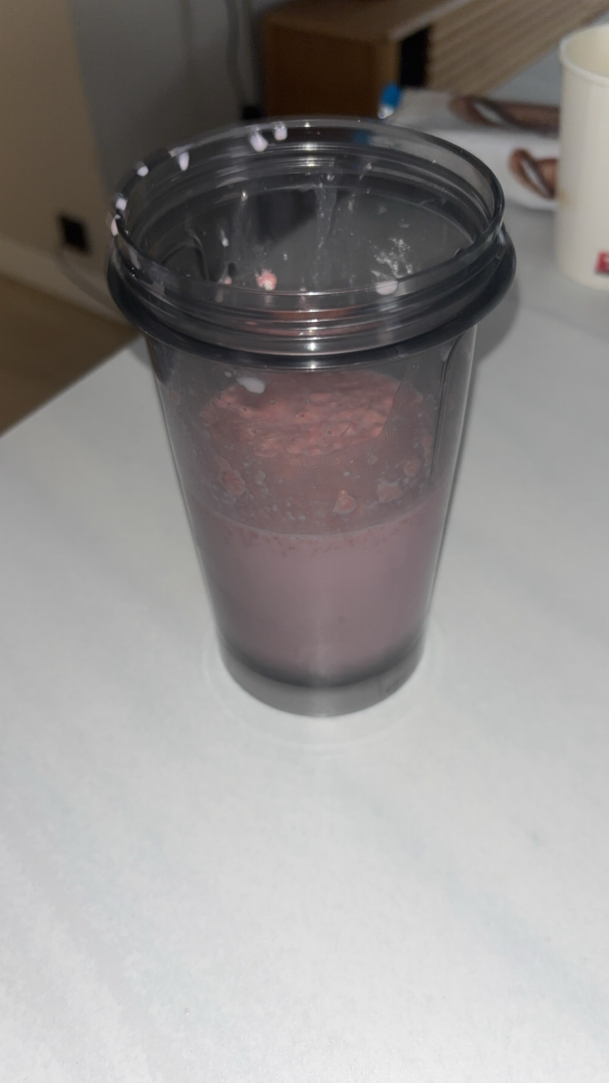 A creamy pink smoothie with a strawberry flavor and light texture.