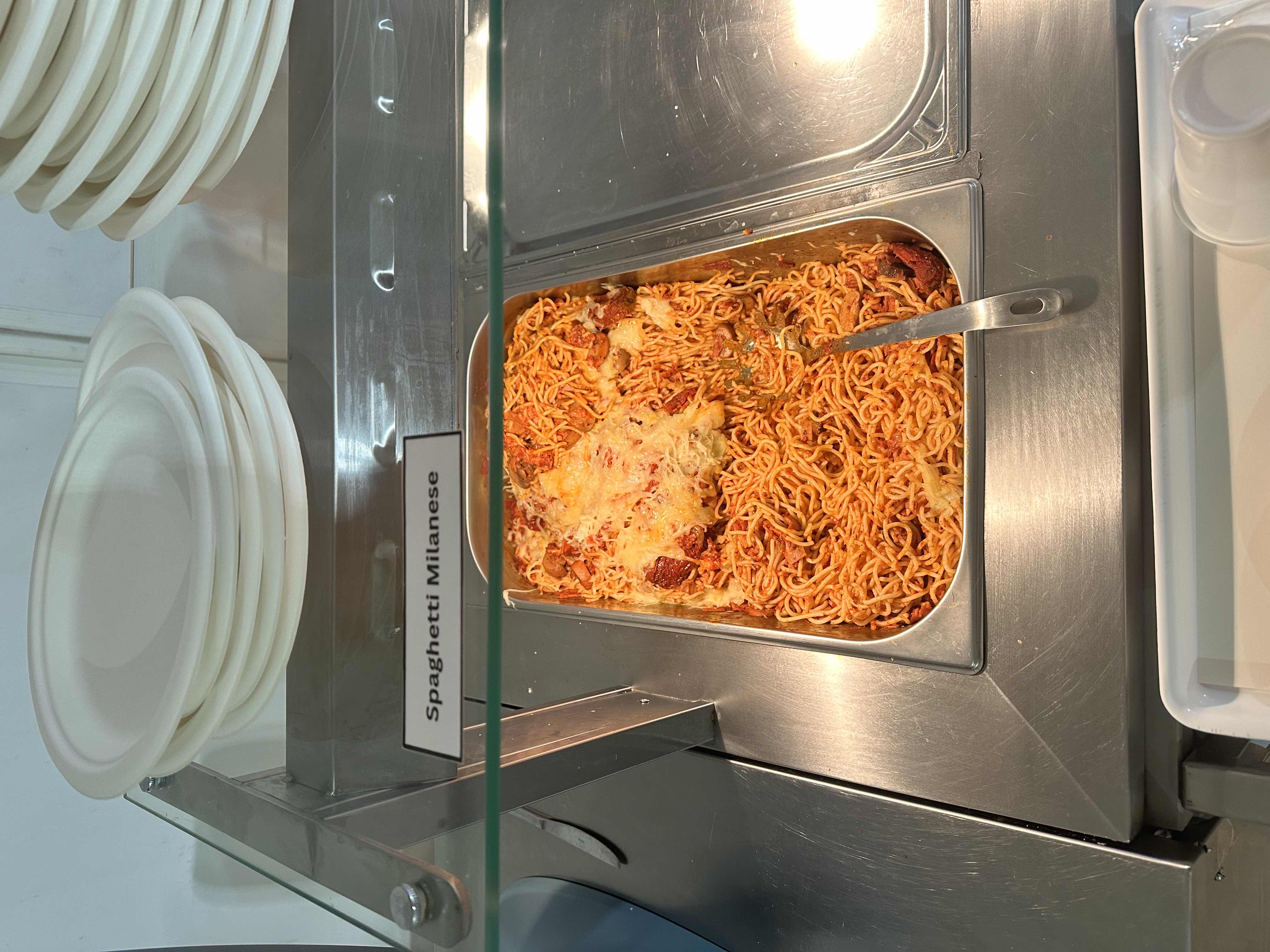 A tray of spaghetti noodles topped with tomato sauce, melted cheese, and savory meat.