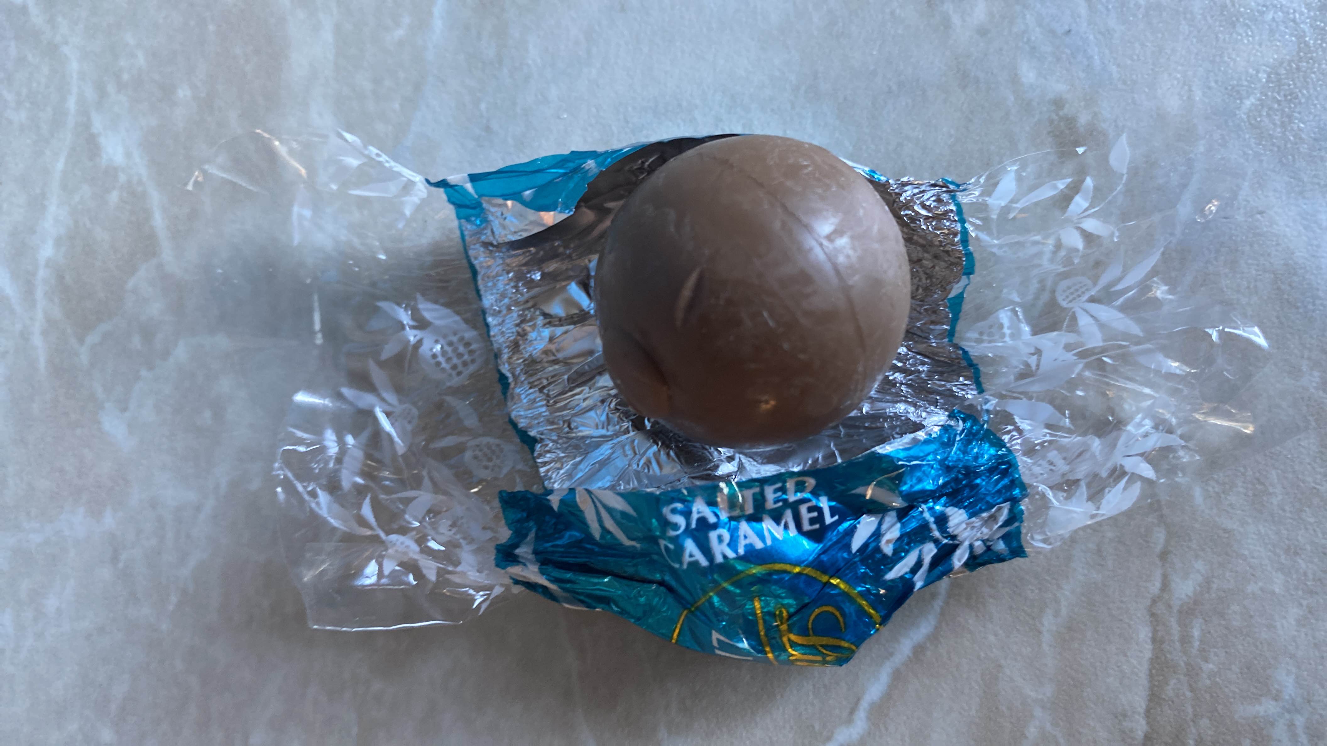 A single salted caramel chocolate with a balance of fats, carbs, and protein, offering a moderate health score.