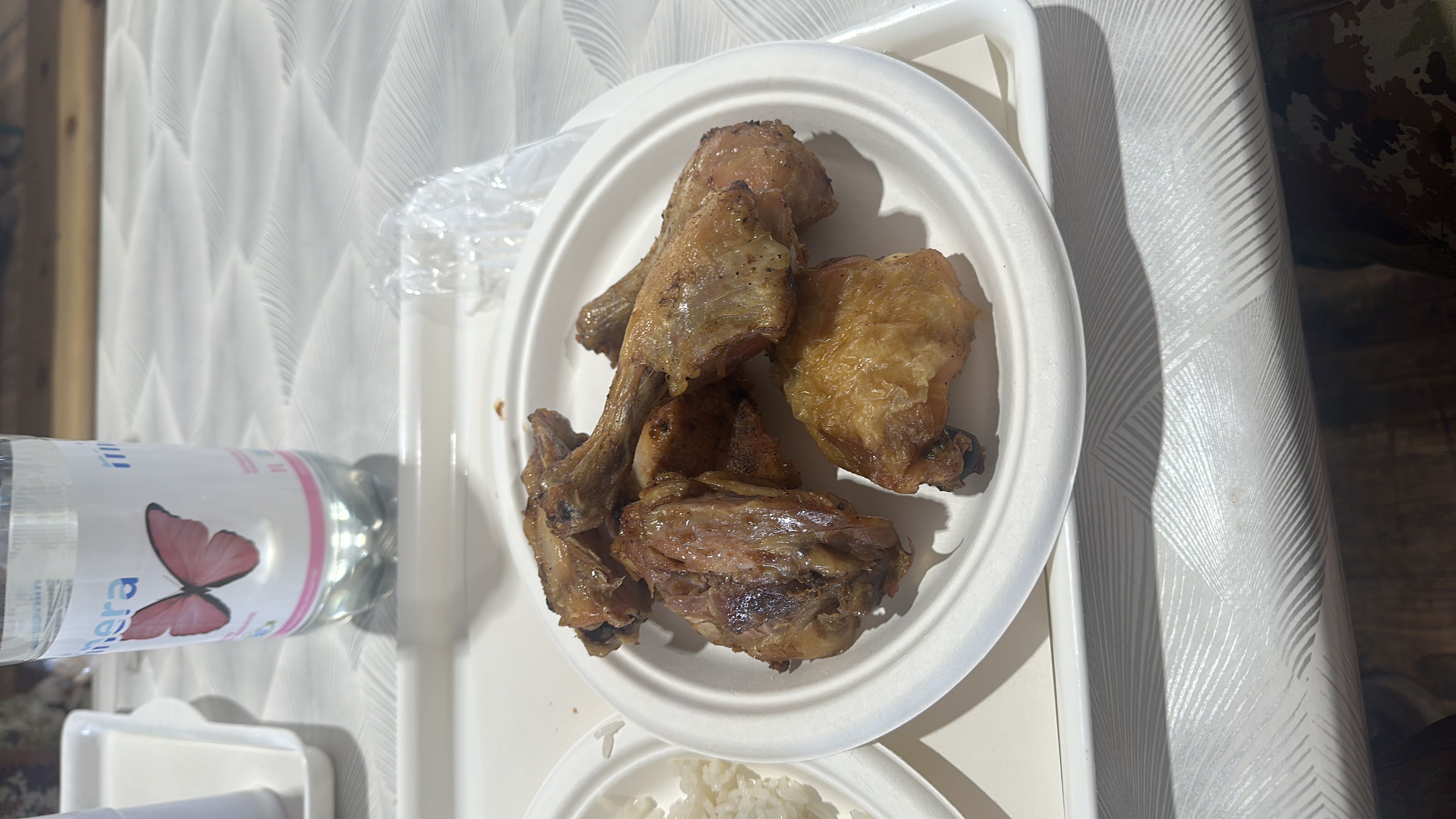 A plate of grilled chicken drumsticks and thighs, served as a protein-rich meal.