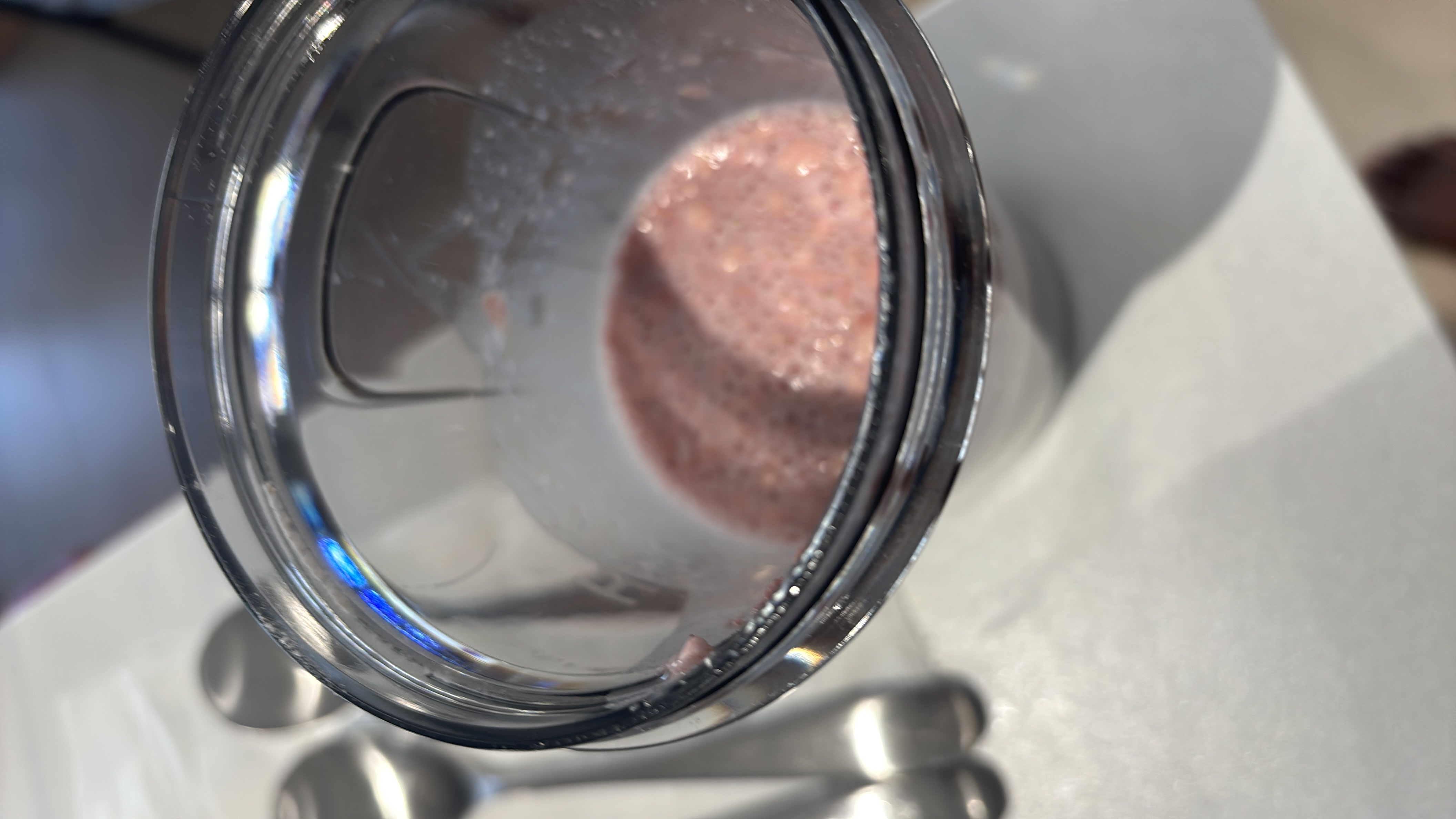 A blended smoothie containing strawberries, milk, and oats, providing a balanced mix of carbs, protein, and fats.