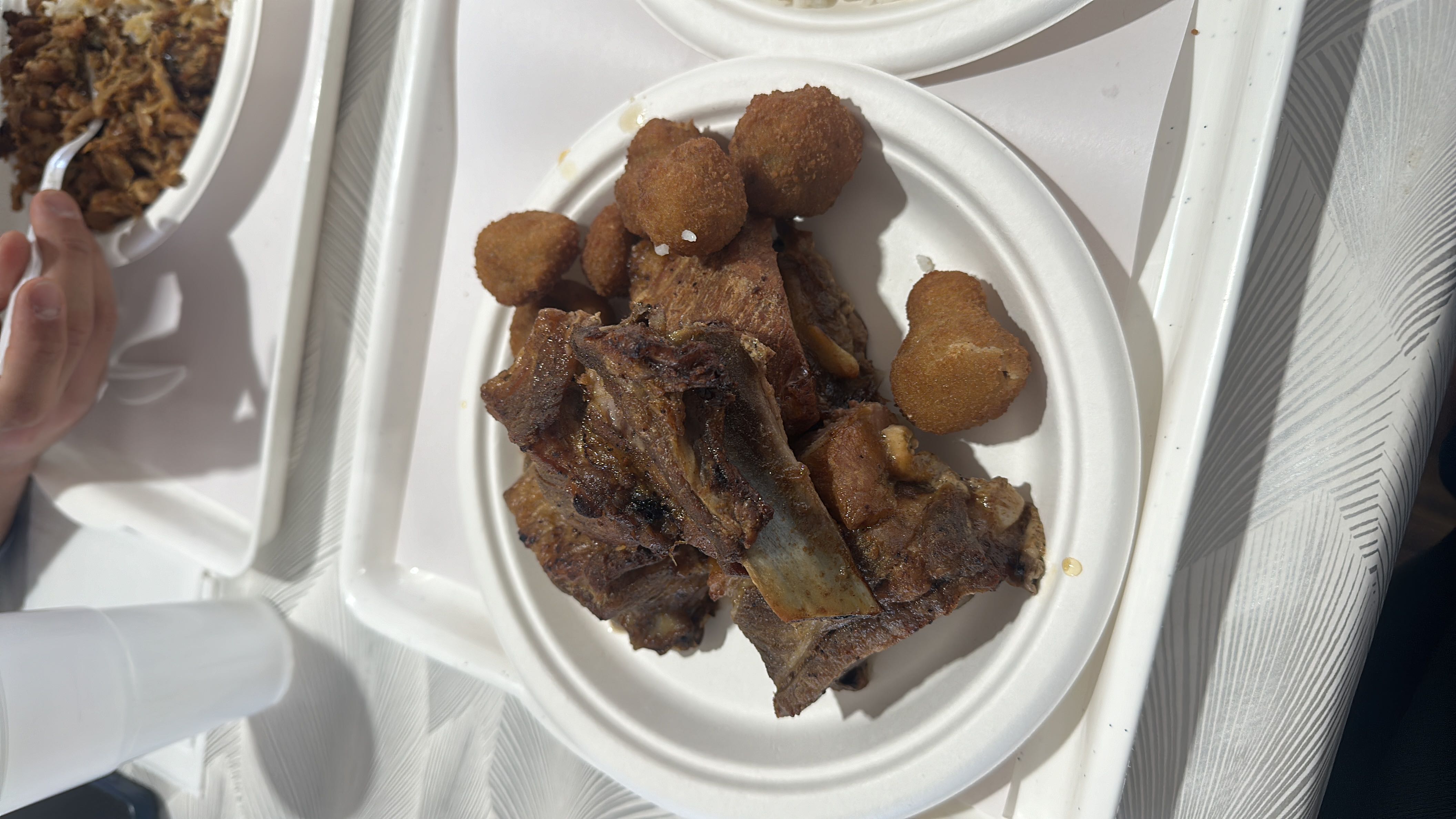 A plate of grilled ribs and fried nuggets, providing a high-protein and high-fat meal with moderate carbohydrates.